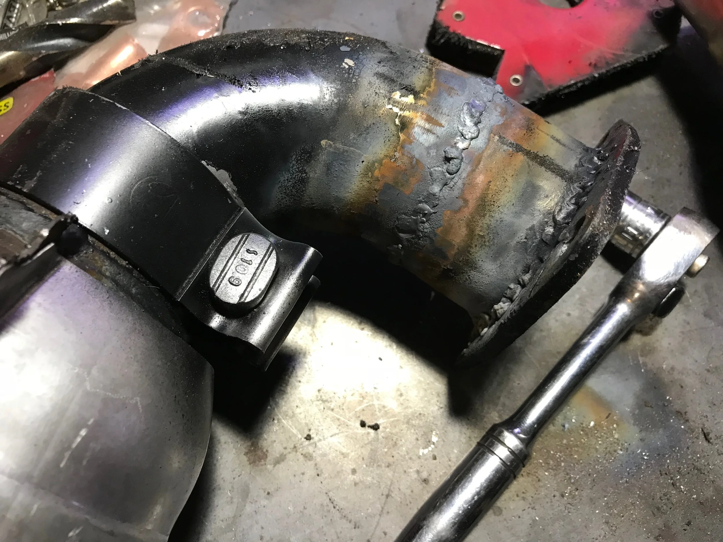 After cutting out a wedge and welding the pipe back together for a proper fit.