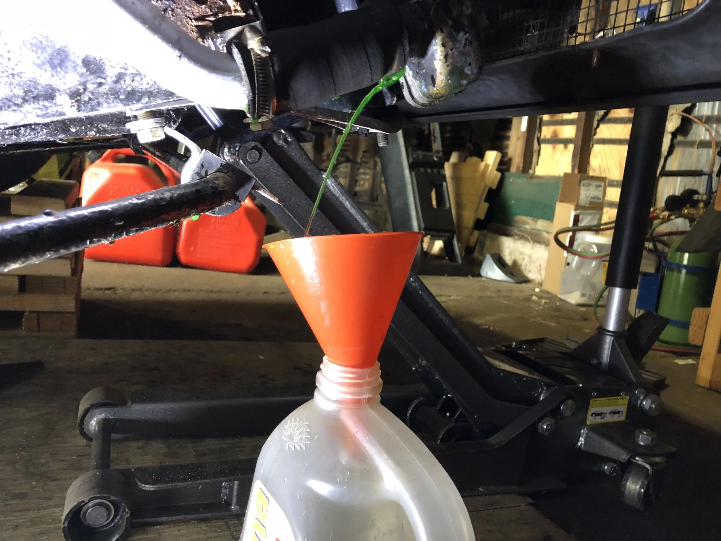 Draining the radiator into a bottle.