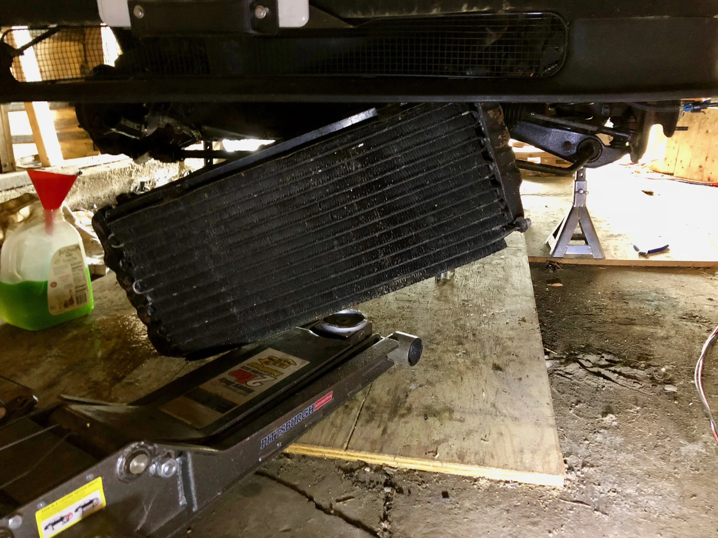 The radiator partially dropped. The upper compressor hose is the only thing keeping it in place.
