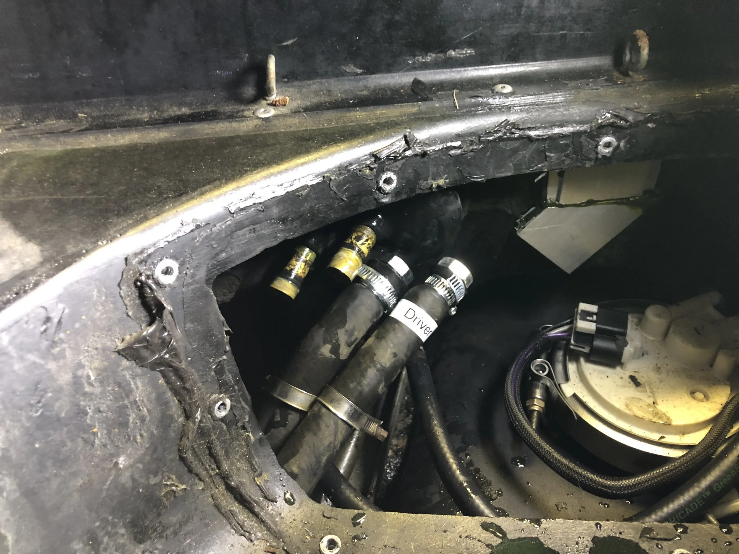 The heater coolant lines capped with bolts hose-clamped in place.