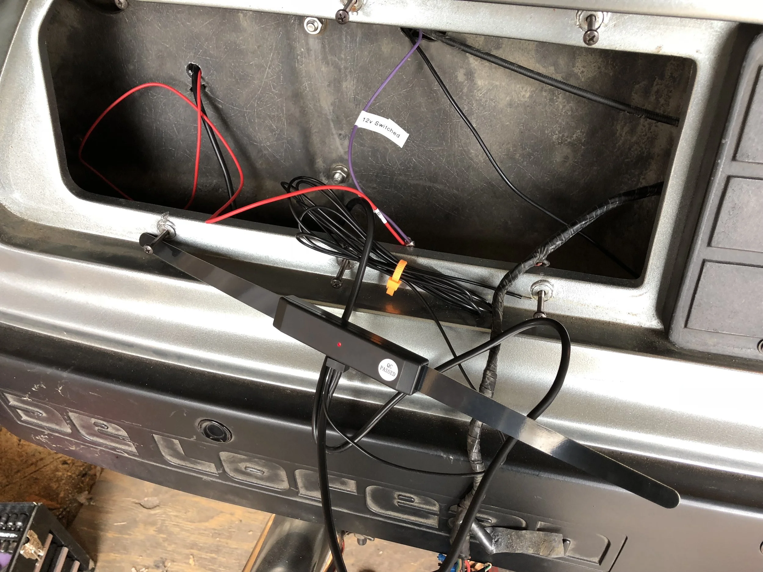 The hidden antenna before installation. Its would be mounted just above the tail light, after running the wires through the driver's side behind the quarter panel. The red LED shows that it is powered and working.