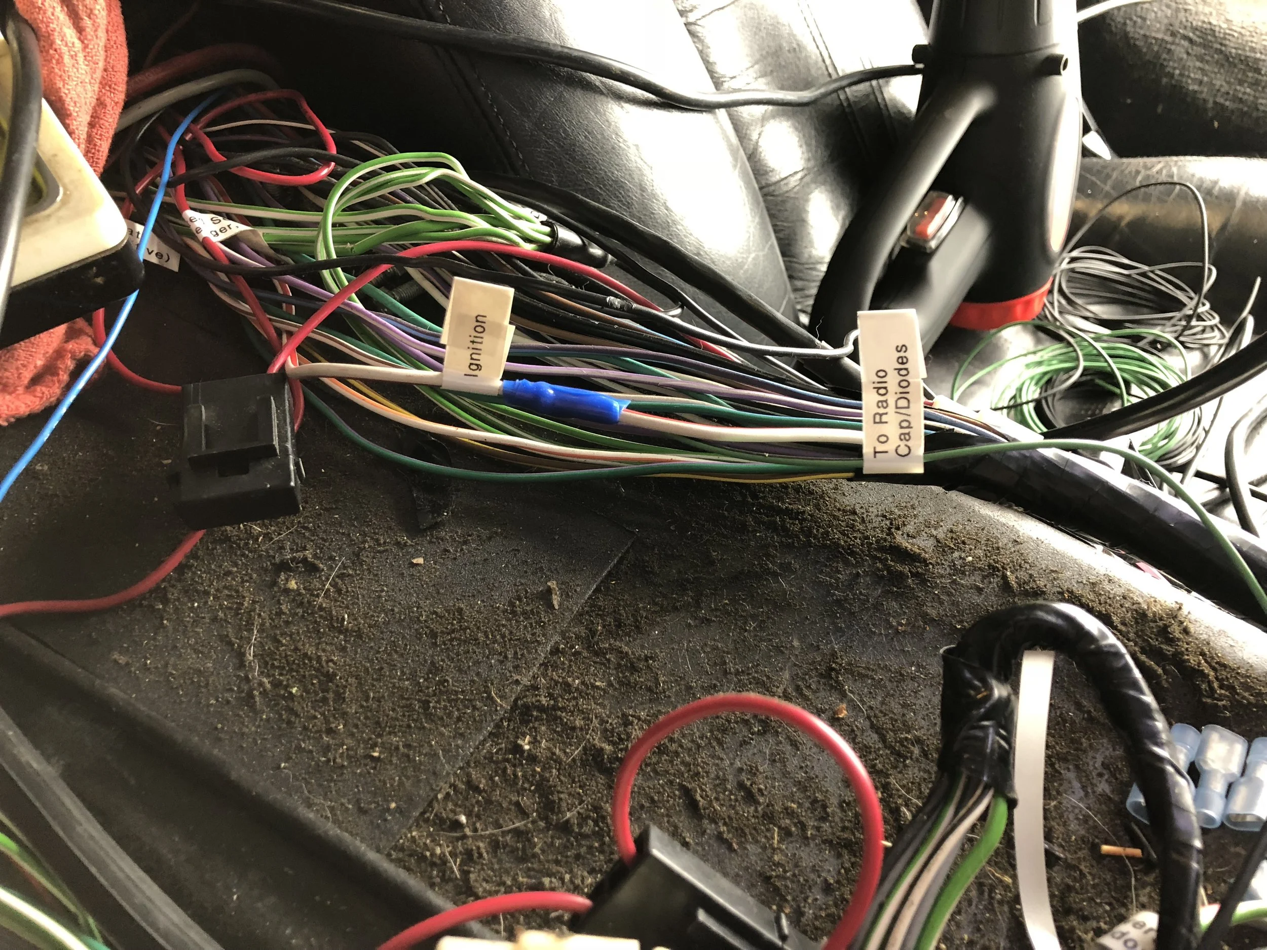 The tap to the red/white ignition wire on the driver's side harness in the center console.