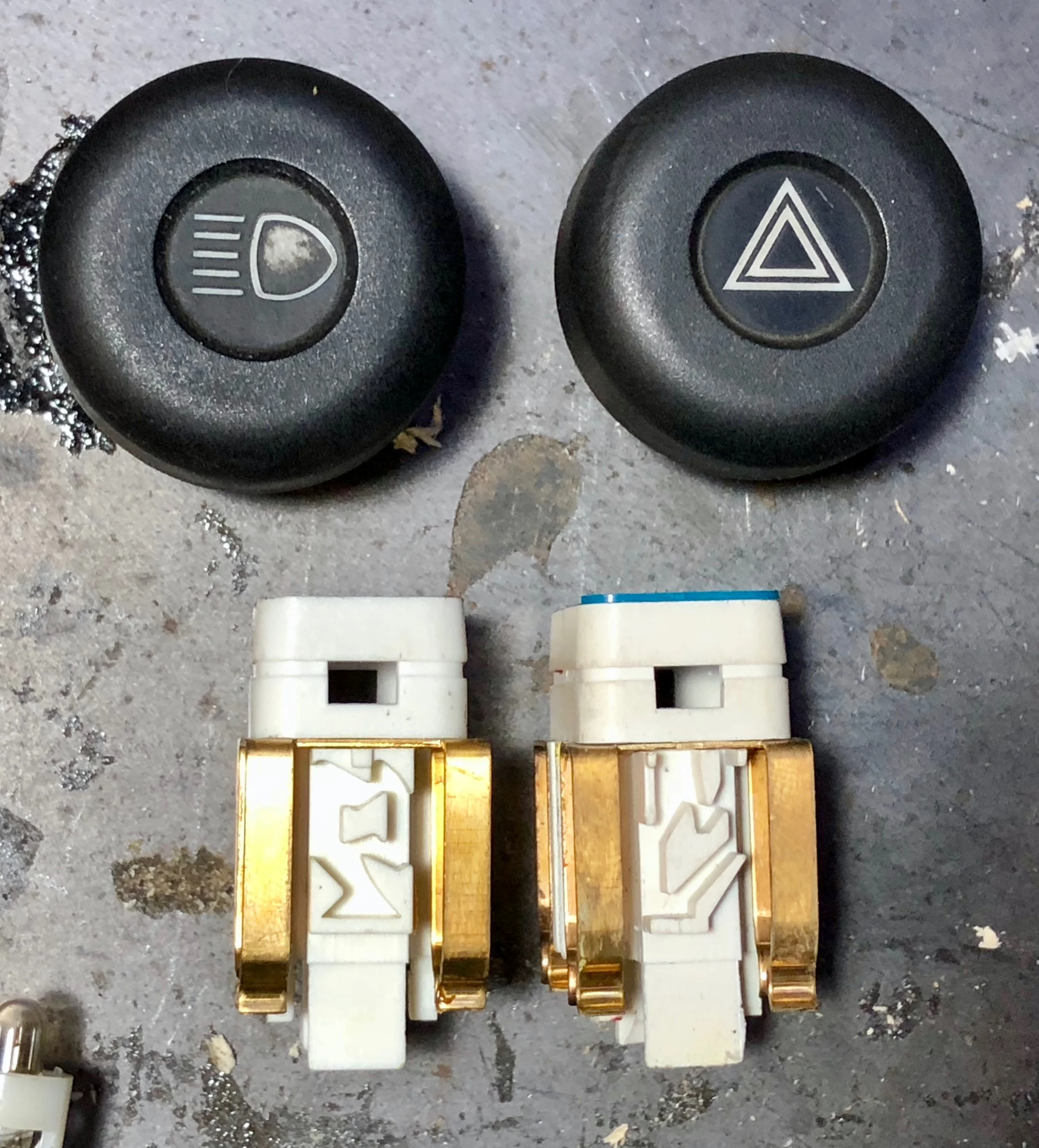 The mazes that the "L" arm follows for the the headlight switch (left) and hazard switch (right), allowing the switch to lock into two or three positions.