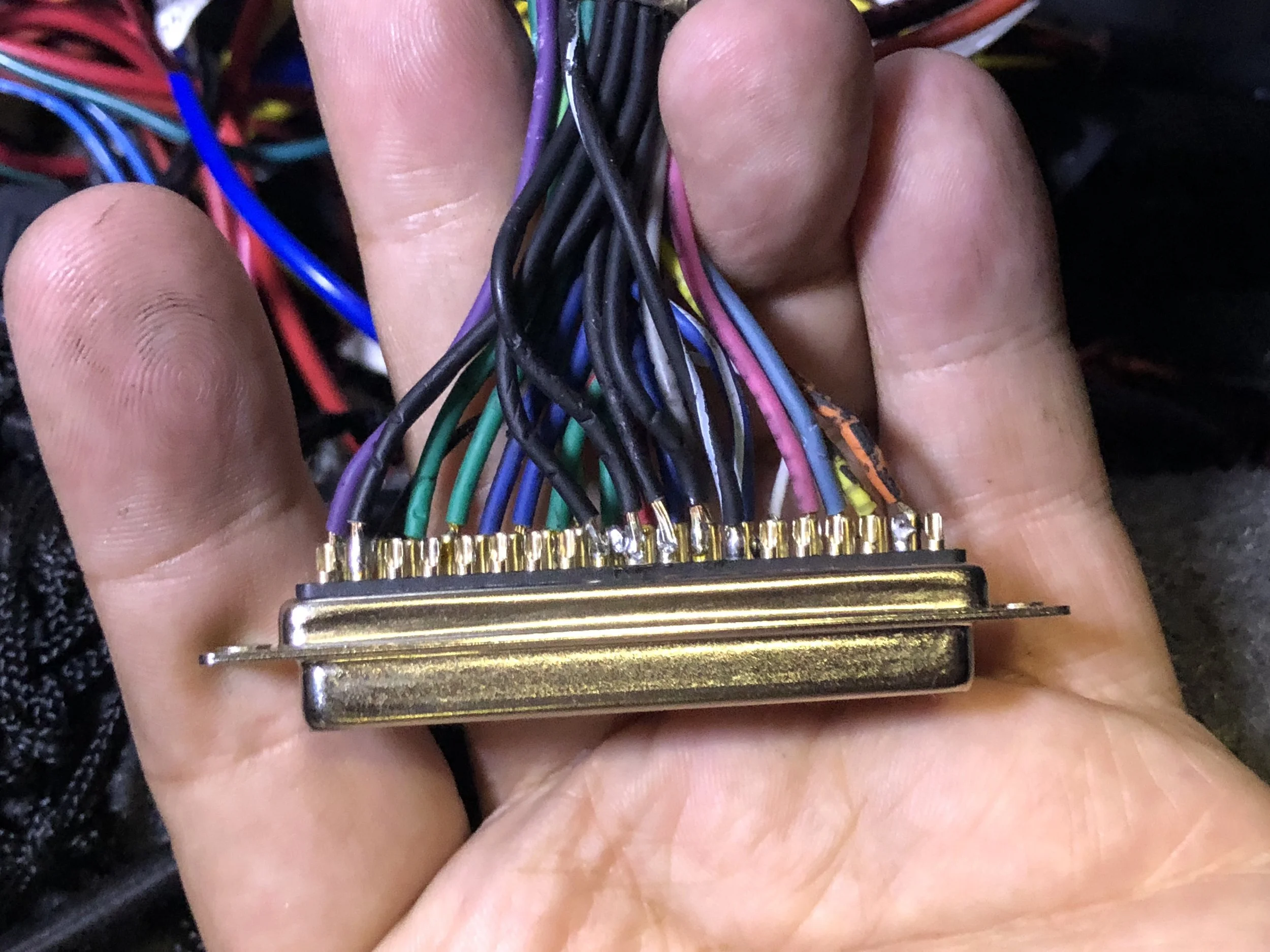 The black ground wires along the top edge of the DB37. The four in the middle should be on the left with the other one. The black/white wire is the sensor return, and is correctly placed.