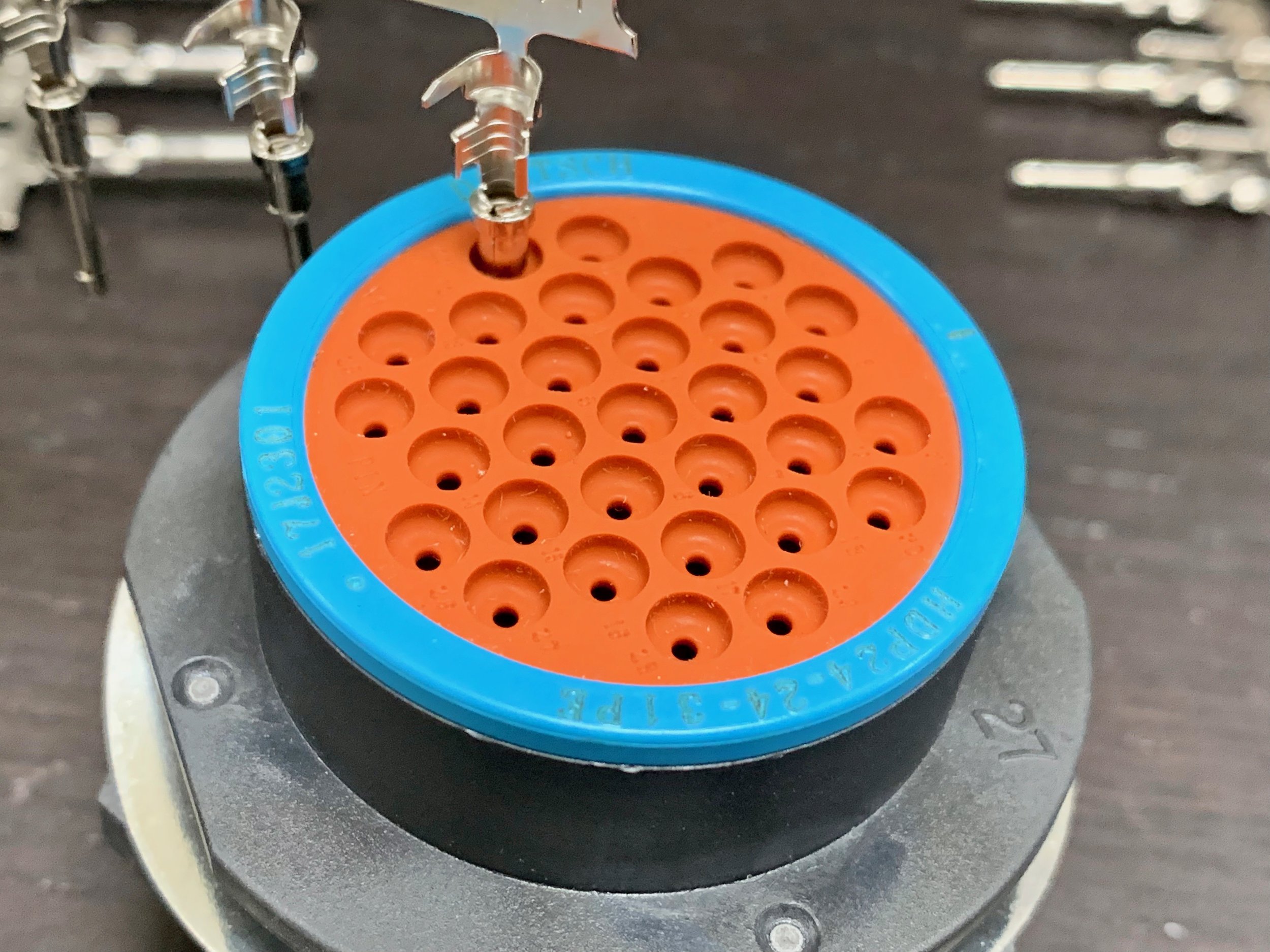 How a pin is inserted into the connector from the back, by simply pushing it through the silicone barrier.