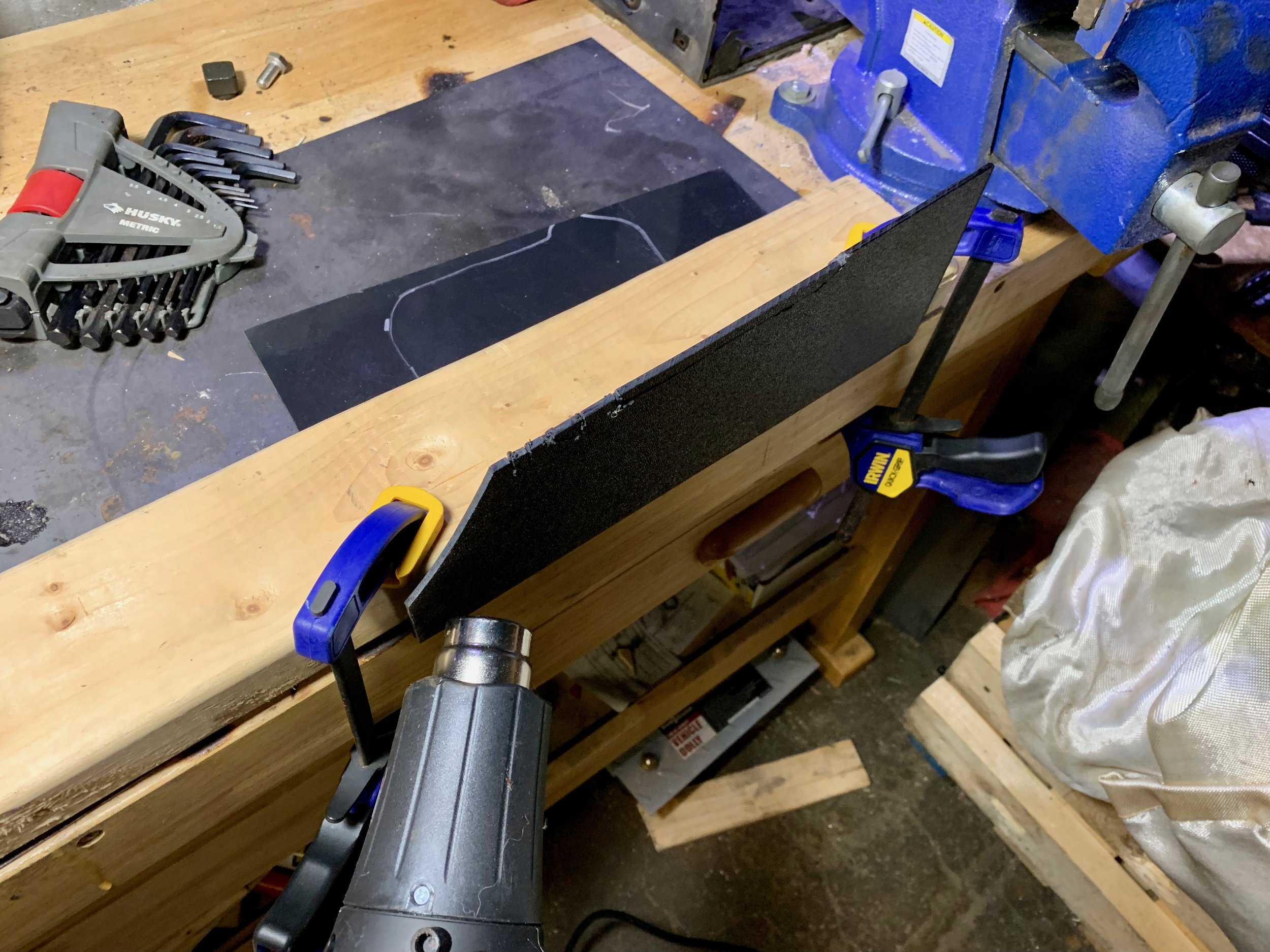 Bending the 1/4” ABS plastic with a heat gun to match the original bend of the metal bulkhead plate.