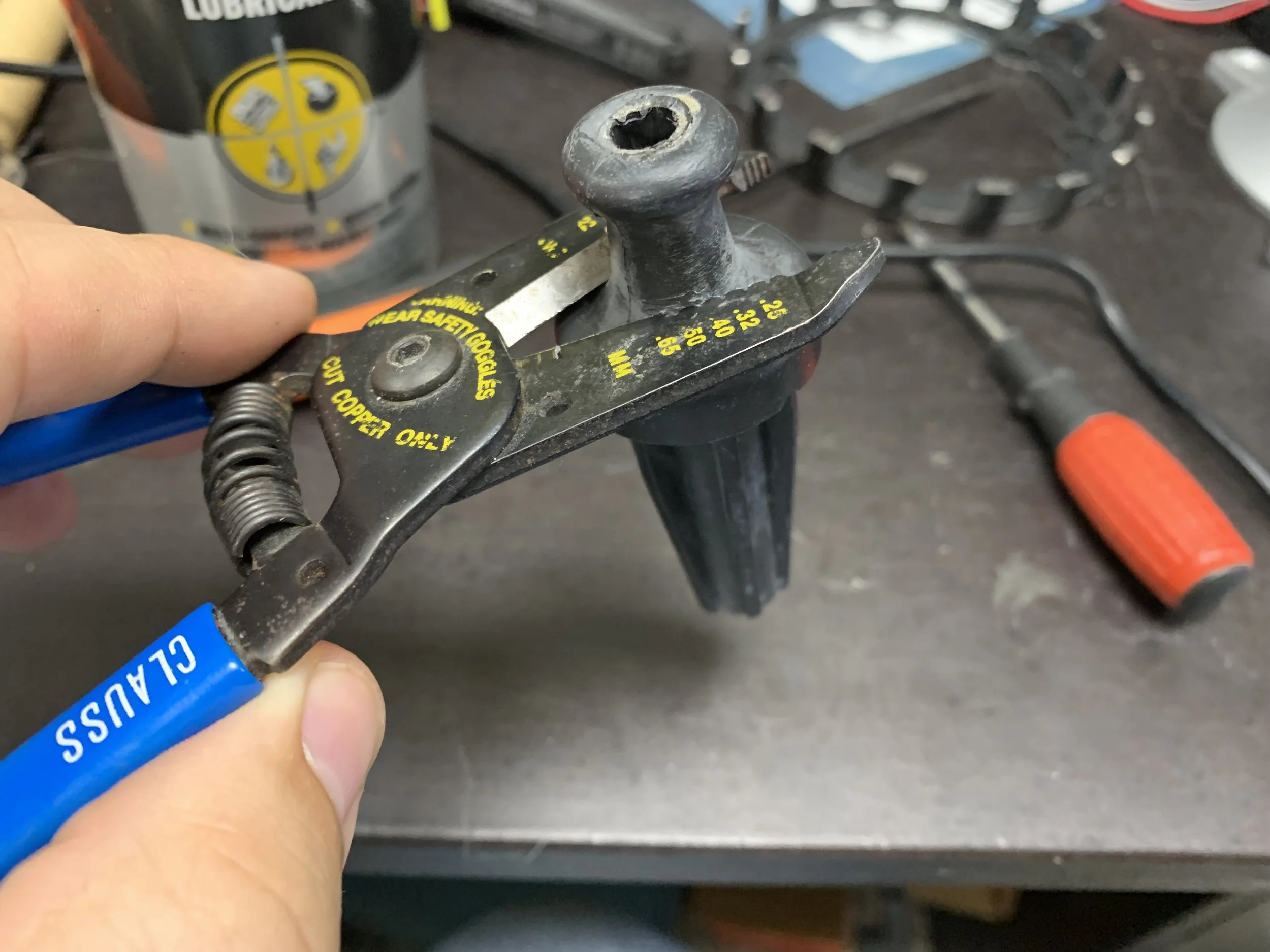 Using wire cutters to remove the top of the boot.