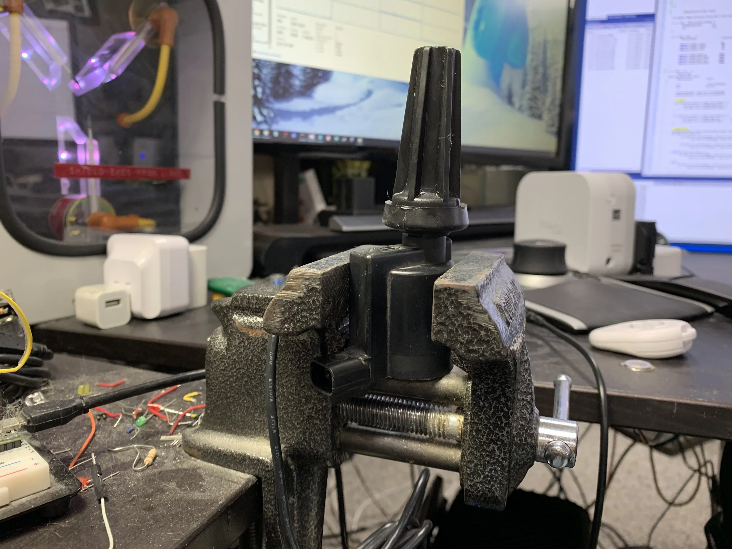 The boot pressed onto the coil, using a vice to hold the coil in place.
