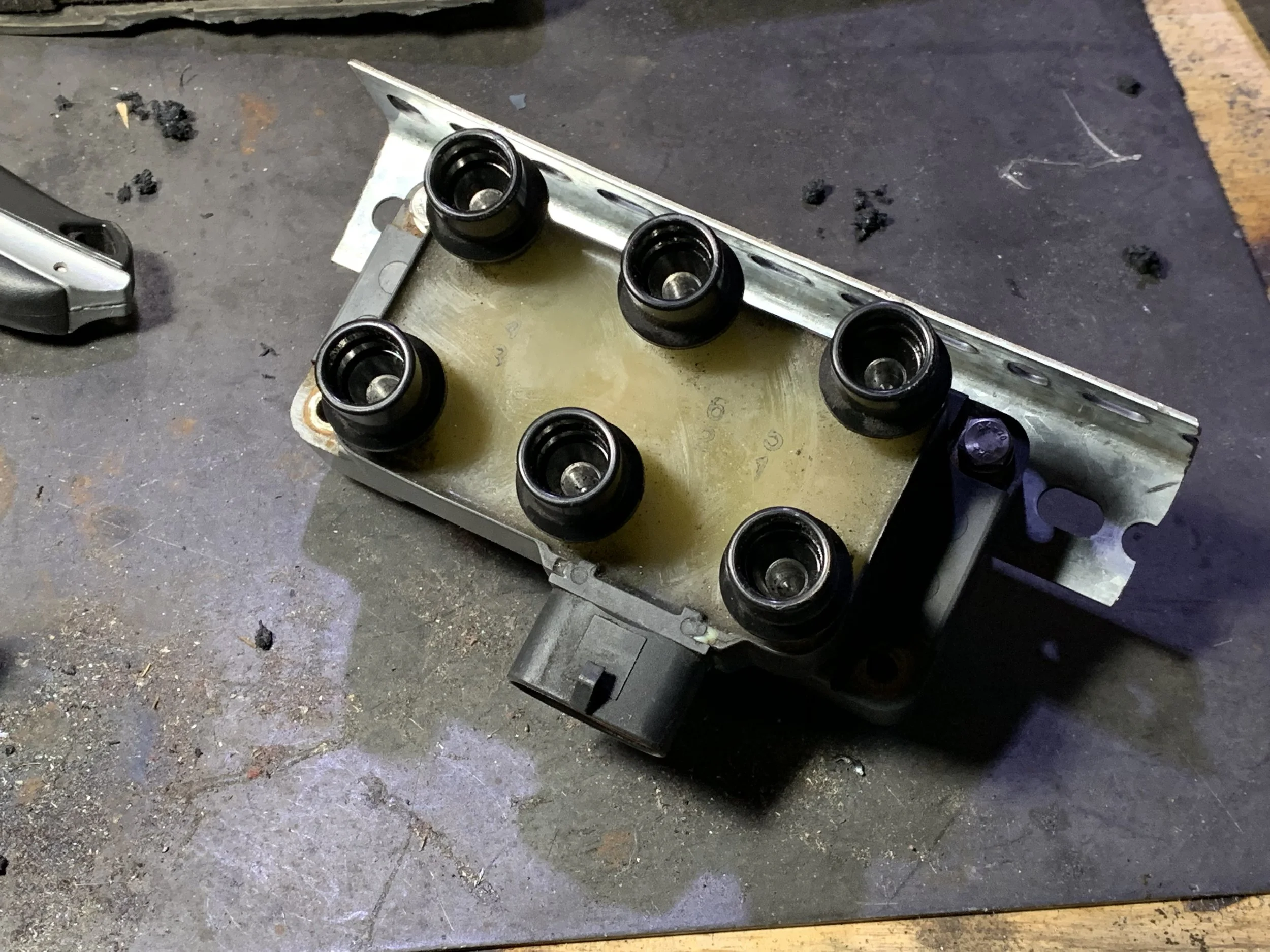 The coil pack mounted on a bracket fabricated from slotted angle stock.