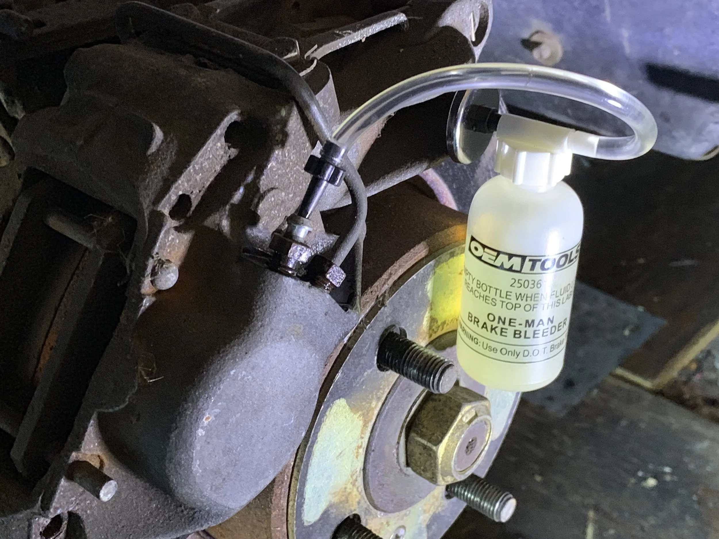 Yellowed fluid is in the bottom of the bottle, while the new fluid is running clear through the hose now.