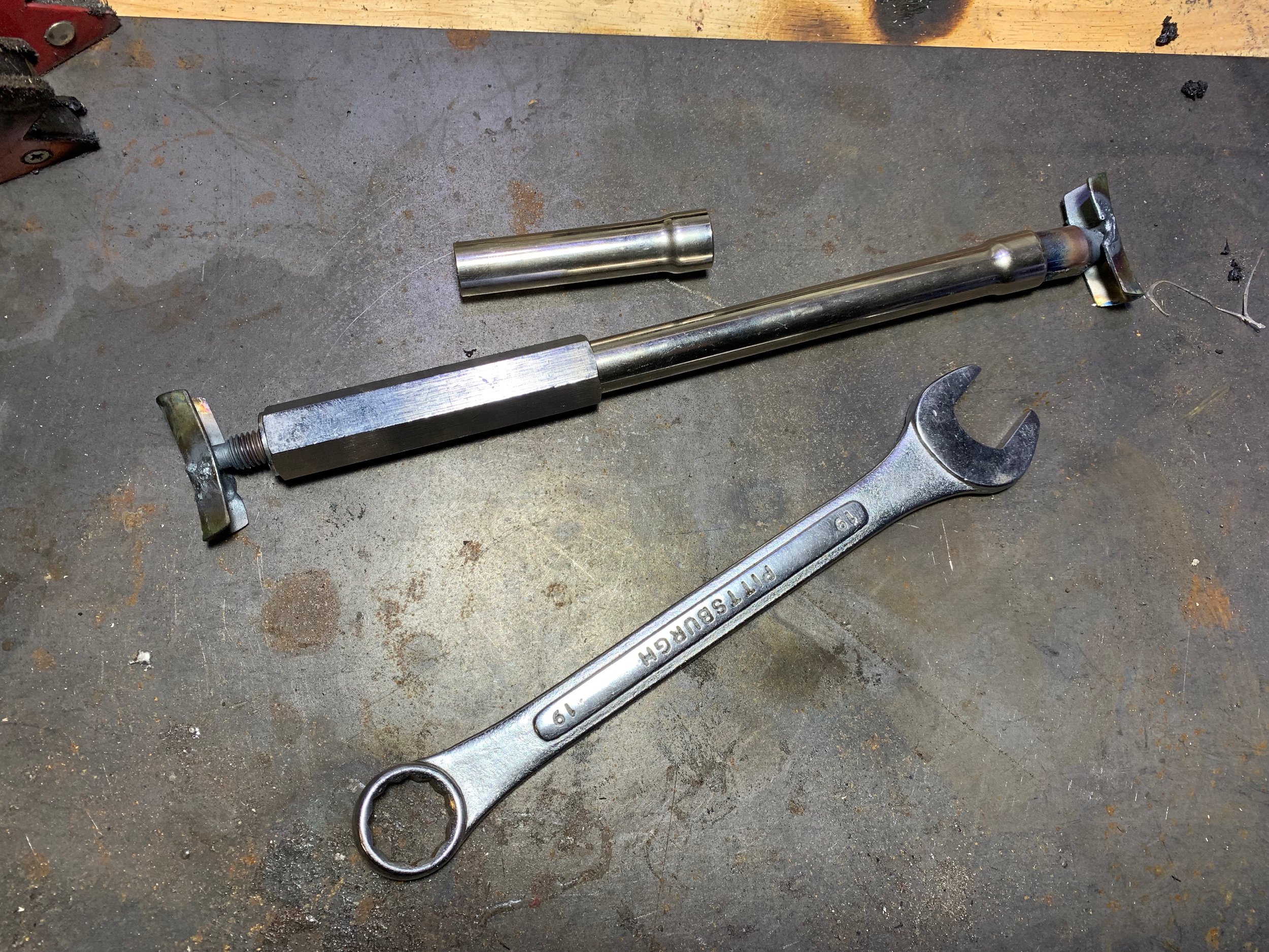 The belt tensioner jack I bought from Amazon, and a 19mm wrench used to turn the jack. The top piece is an extra extension for longer pulley distances.