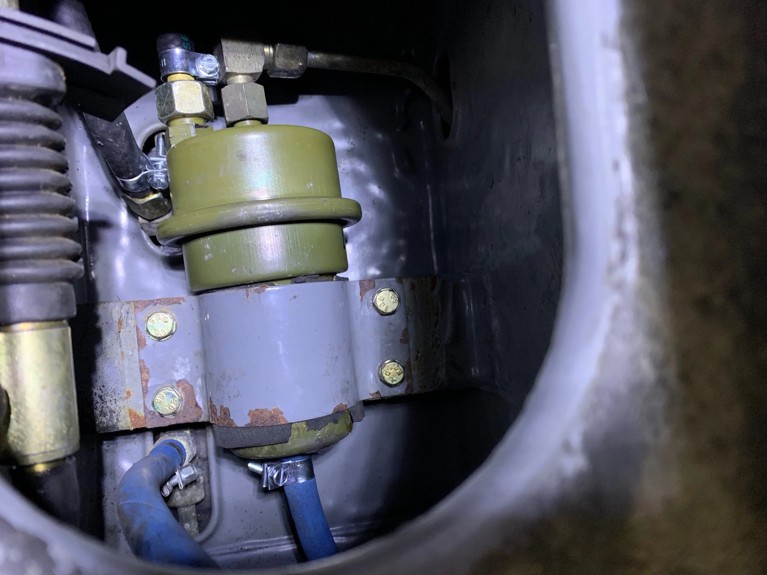 The newly installed fuel line and re-mounted accumulator. The hose extends forward into the frame, but could run against the shifter linkage, which is probably bad.