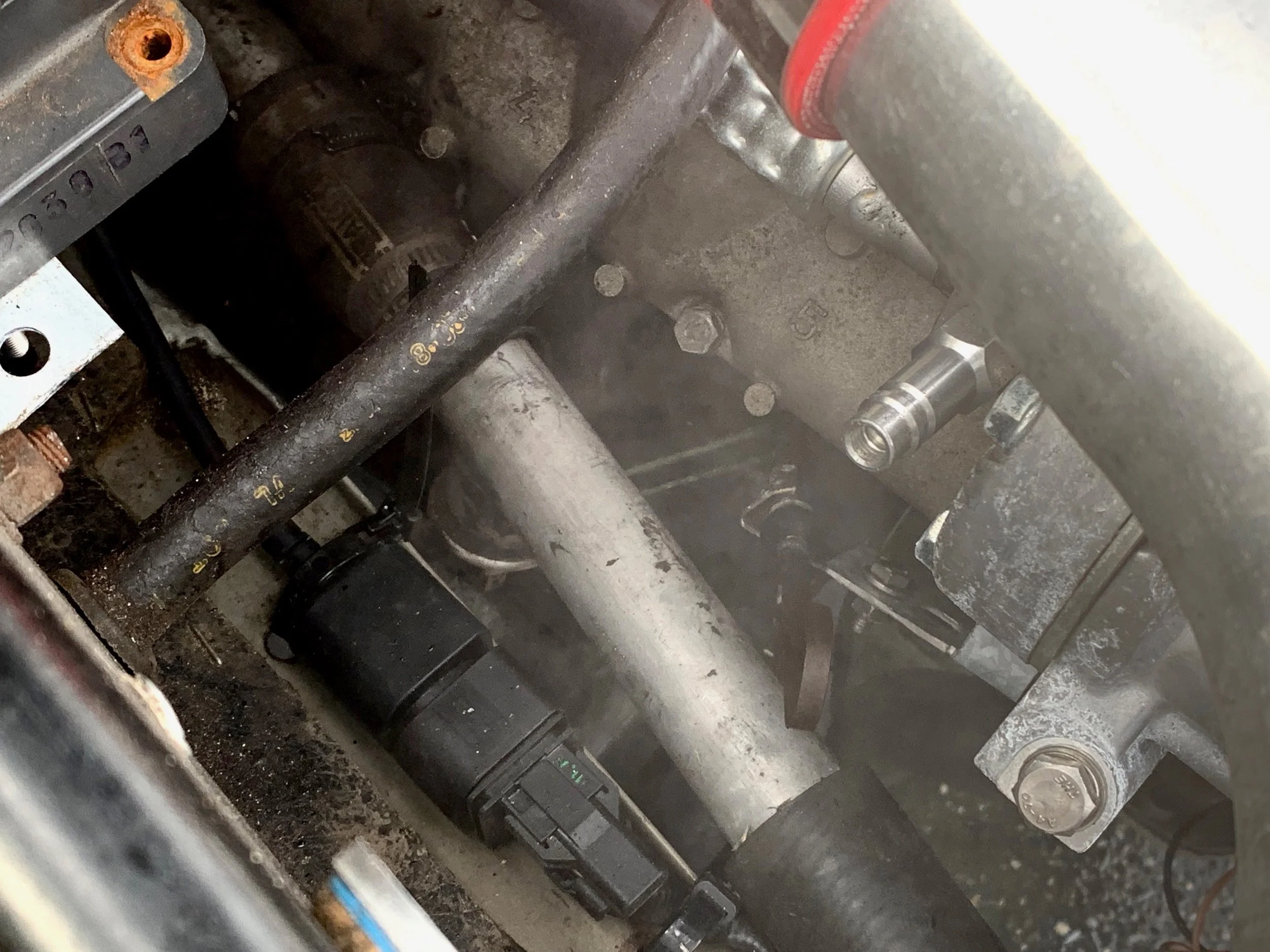 Two streams of coolant shooting out the side of the otterstat and down the headers.