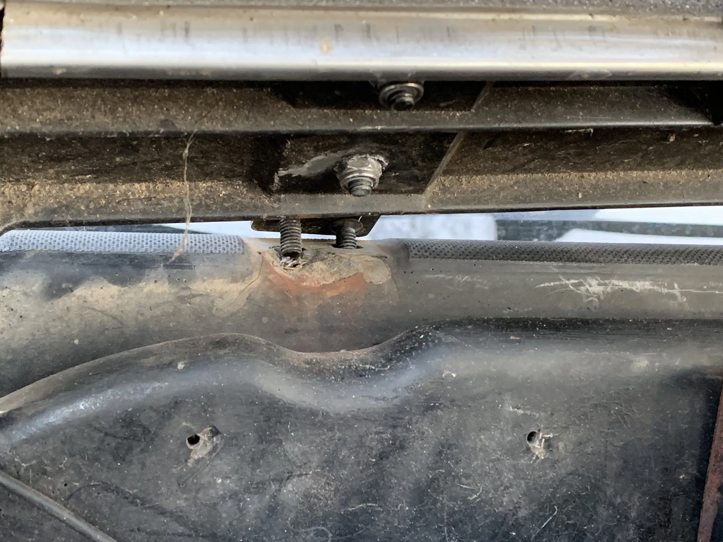 The engine cover hinge is clearly no longer bolted down.