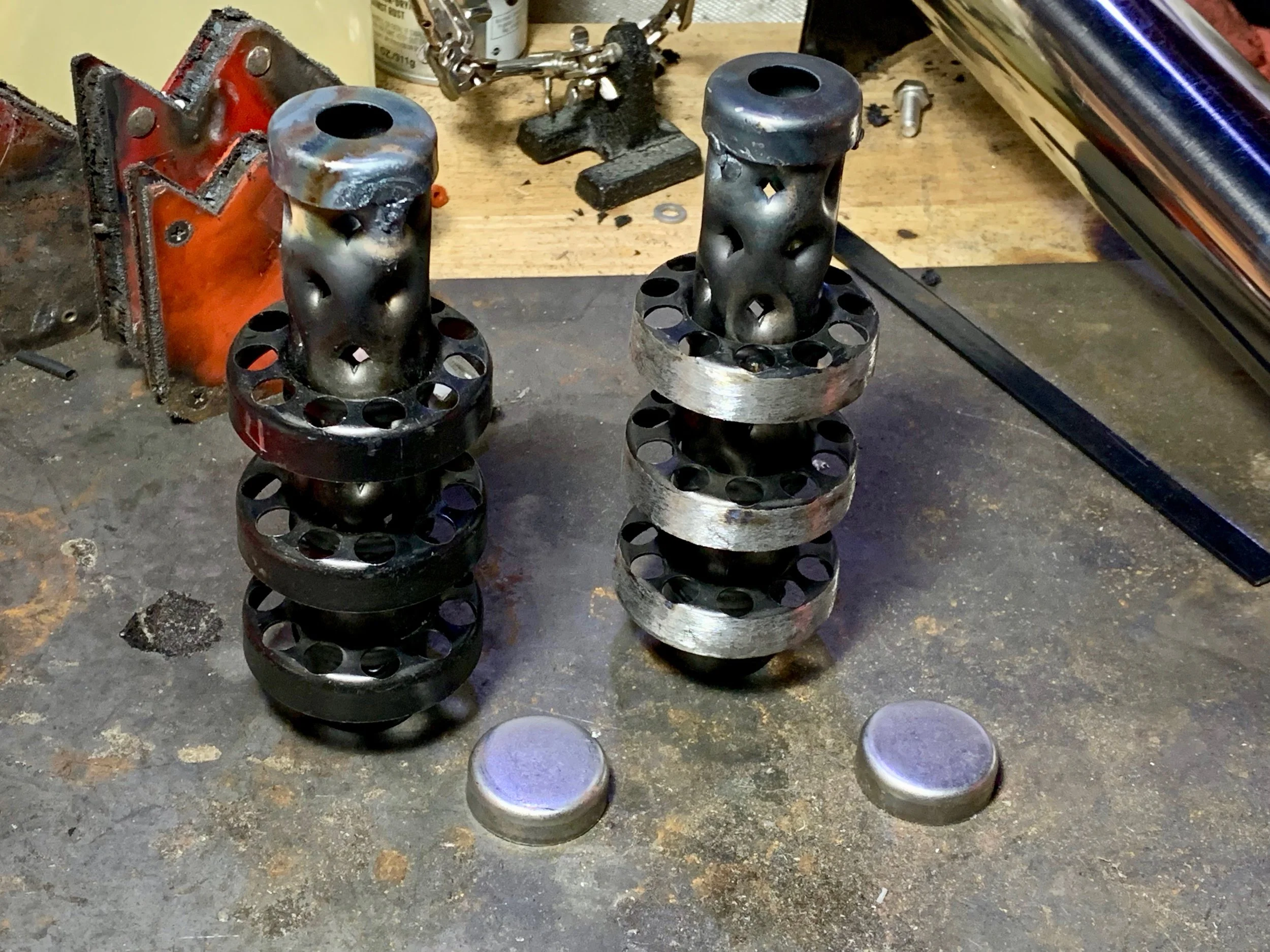 The silencers with their caps welded on the intake side. The one on the right has had its paint and some metal ground down so that it would fit in the pipes, while the one on the left sill needs to be ground.