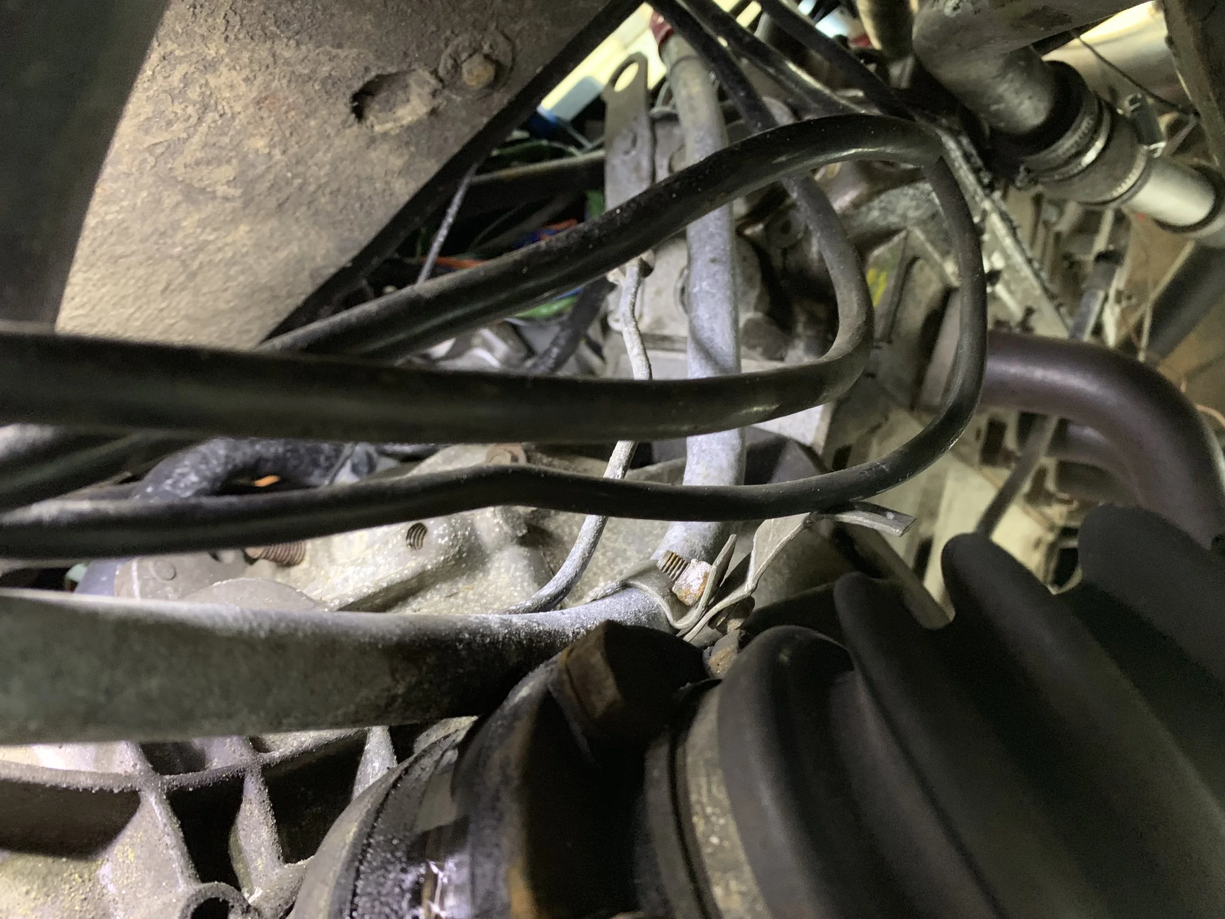 The dipstick tube sitting on top of the axle. You can also see the bracket that is supposed to be mounted tot he cylinder he’d resting on the bend in the tube.