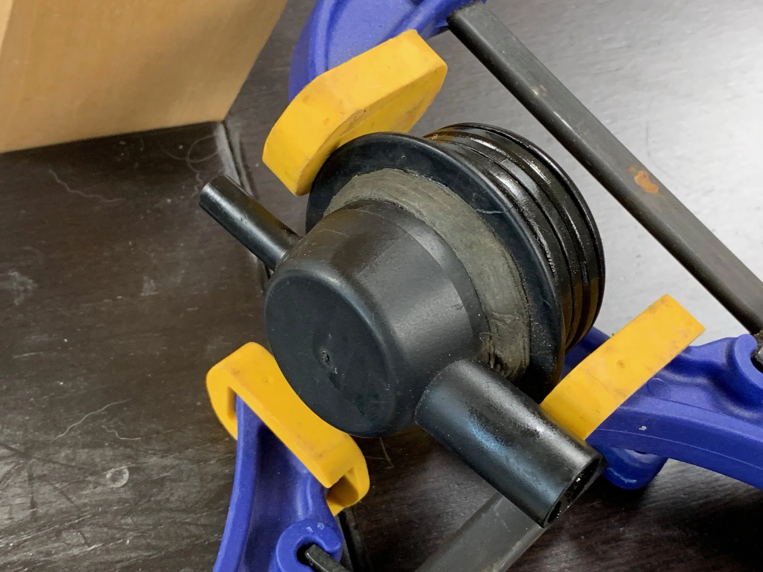 The repaired vent thing, clamped while the epoxy dries.