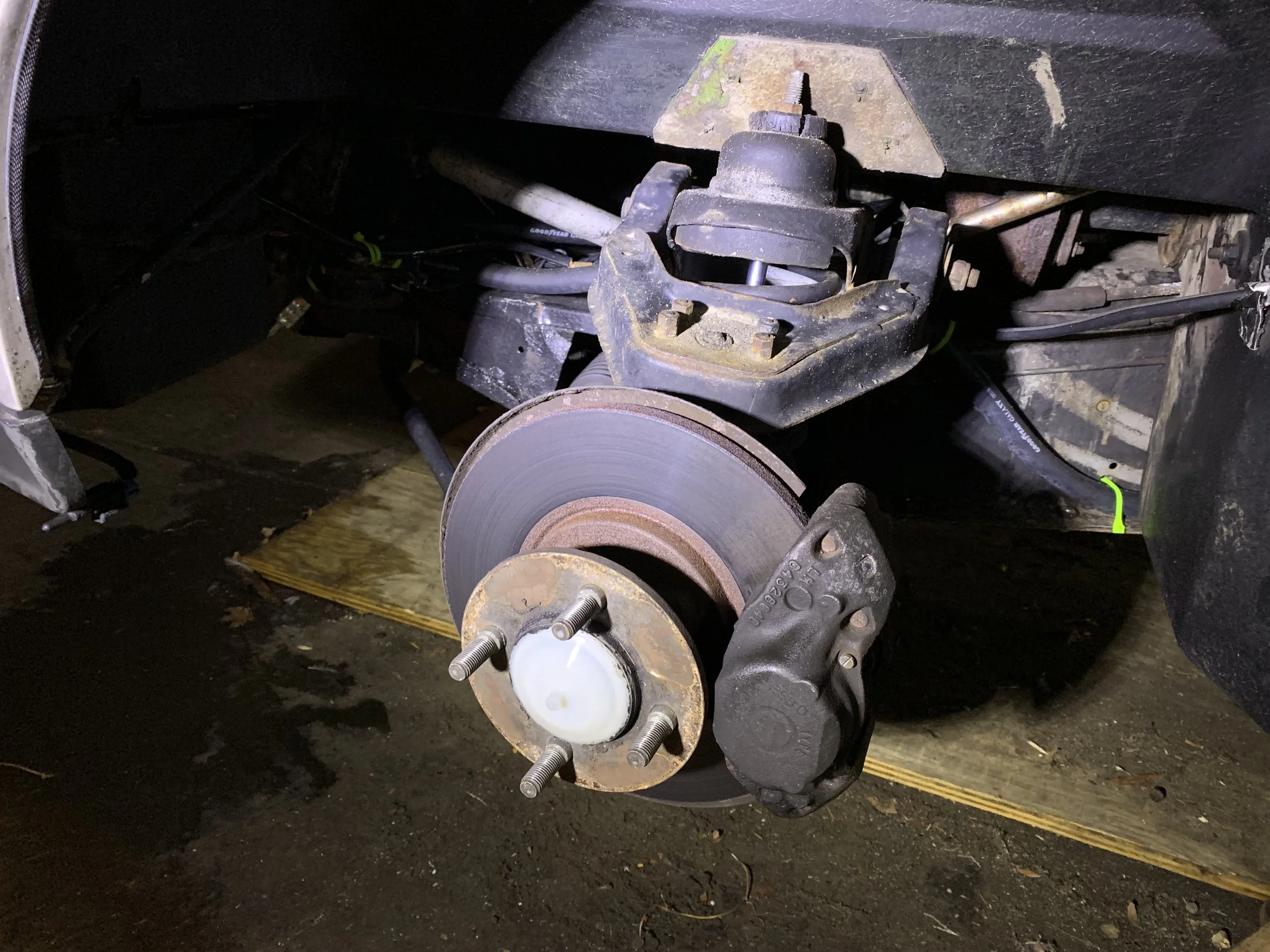 With the wheel off, the hub, caliper and angle drive dust cap covering the hub nut are visible.
