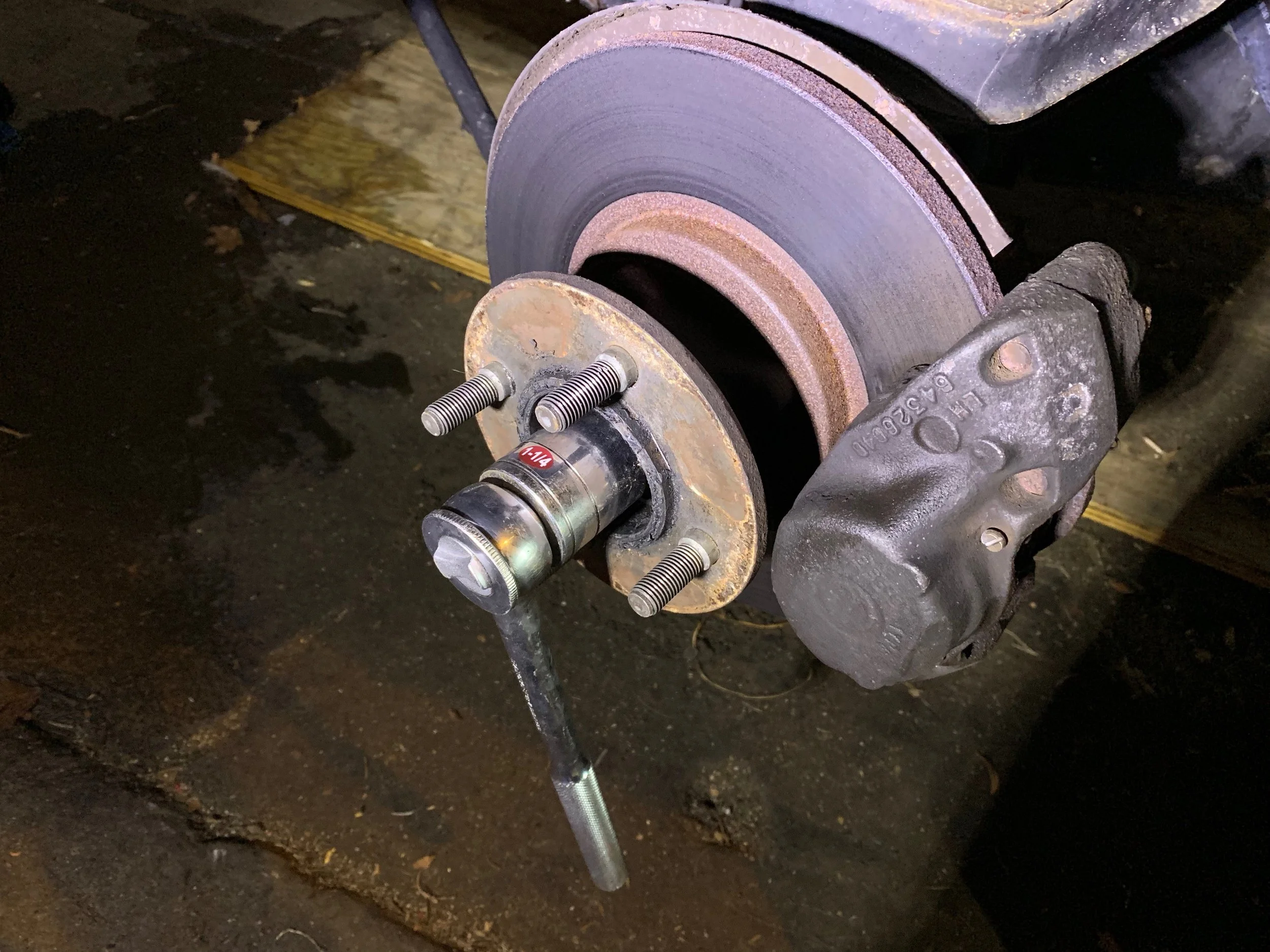 Using a 1 1/4” wrench to remove the center nut.