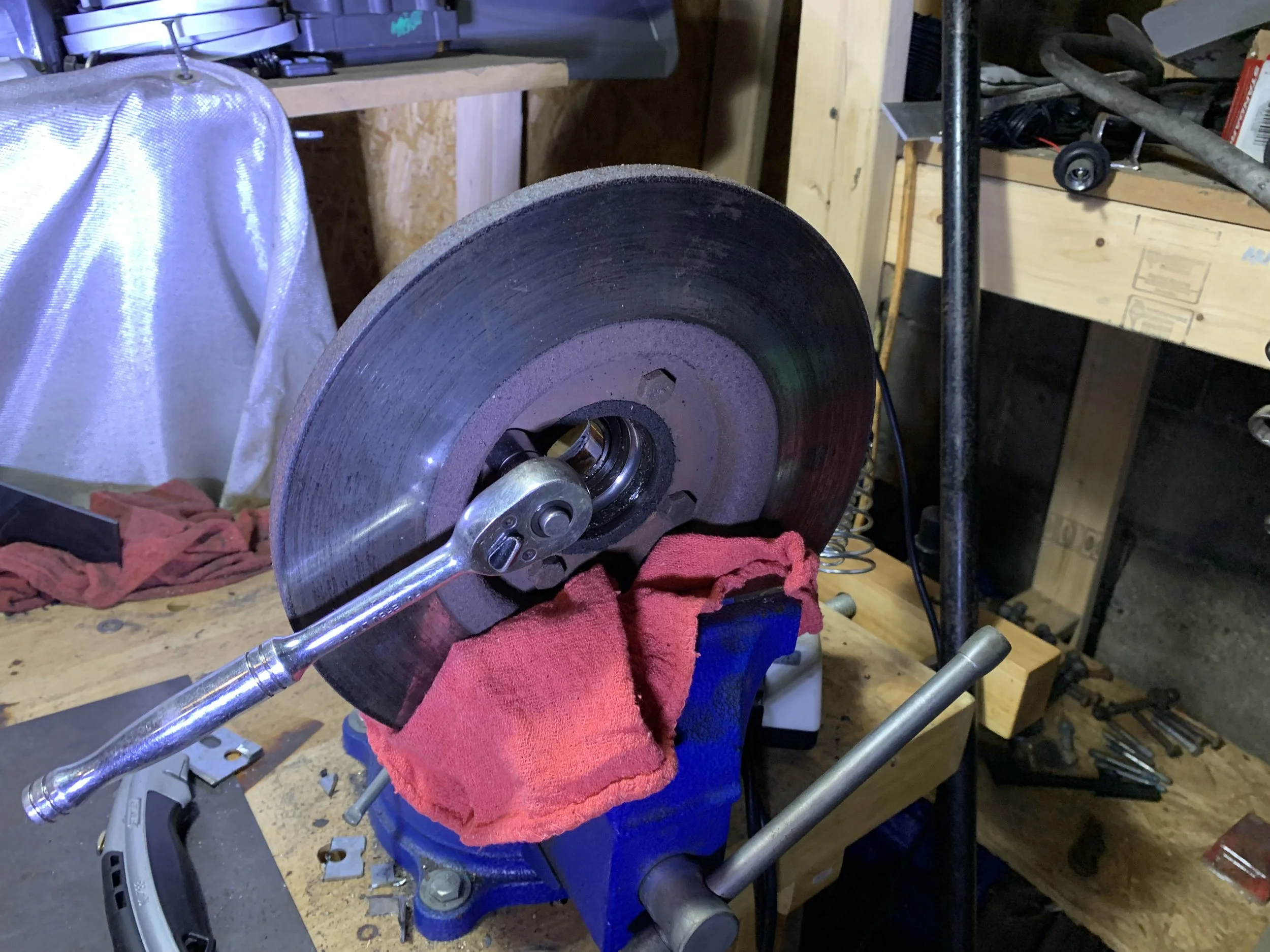 Using a socket wrench to remove the bolts securing the hub to the rotor.