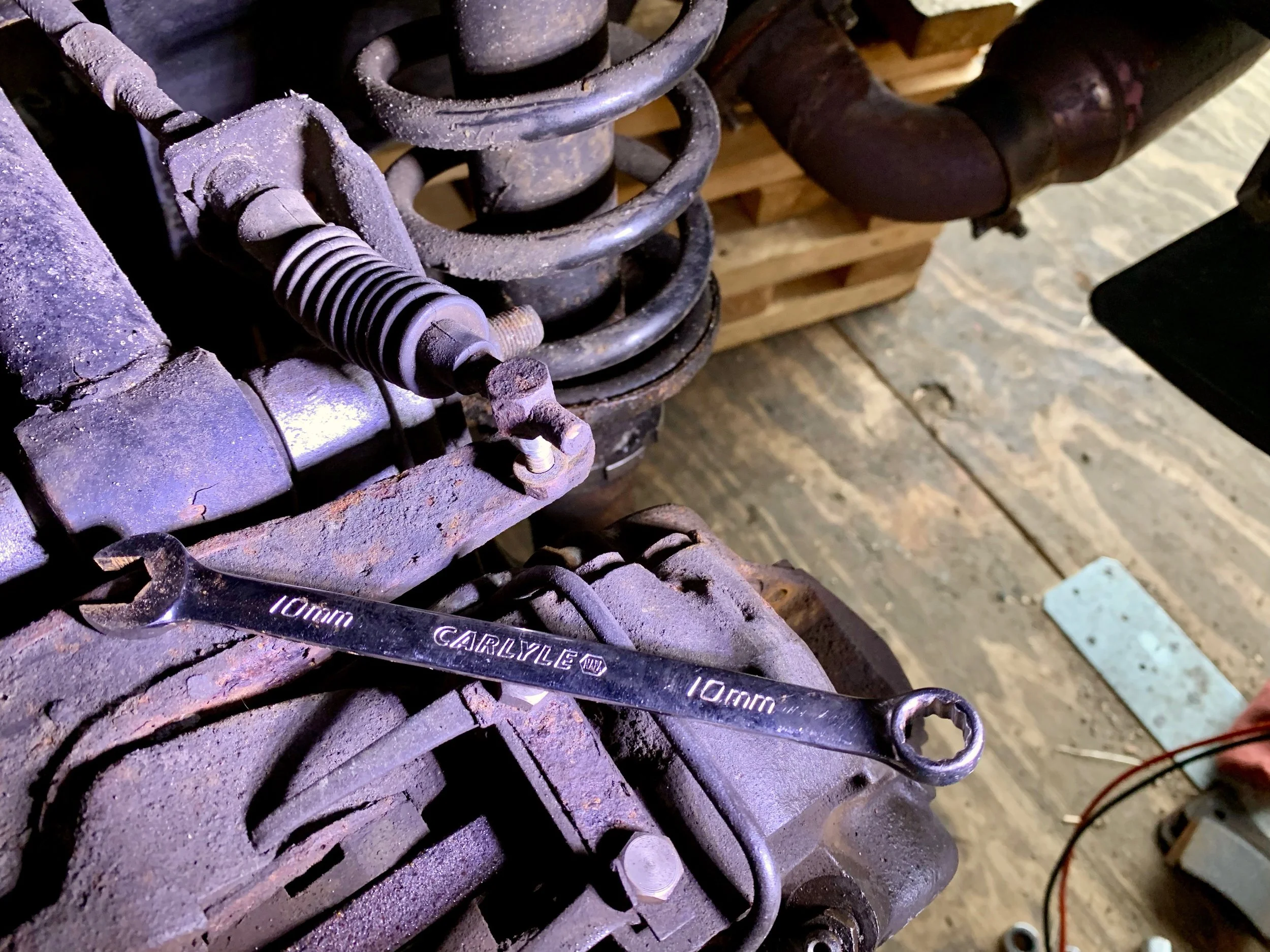 Disconnect the e-brake cable with a 10mm wrench.