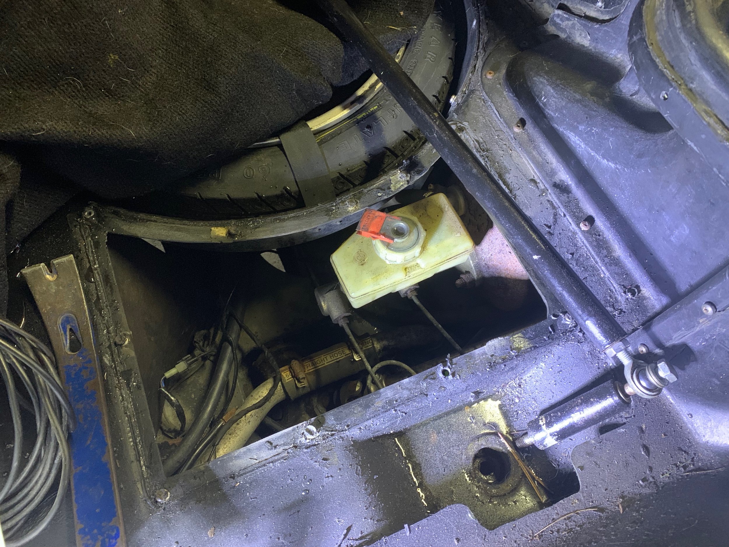 The brake master after removing the access panel in the trunk.