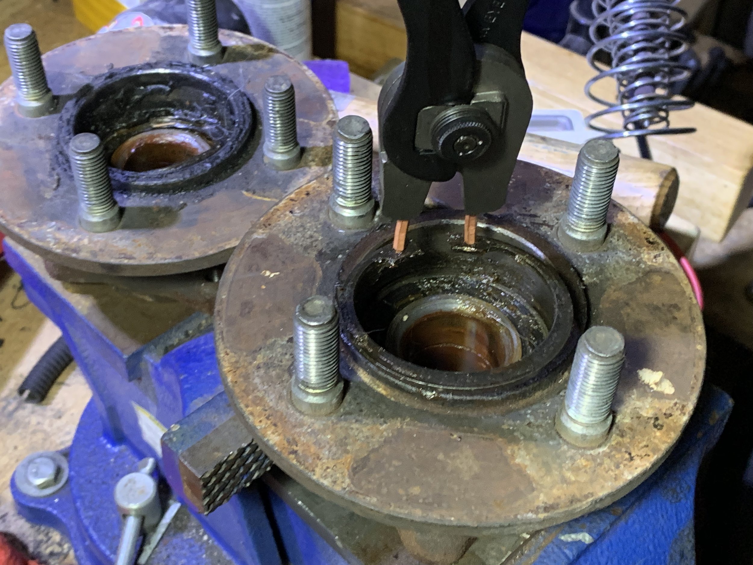 Using retaining ring plies to remove the training ring that holds the bearing to the hub..