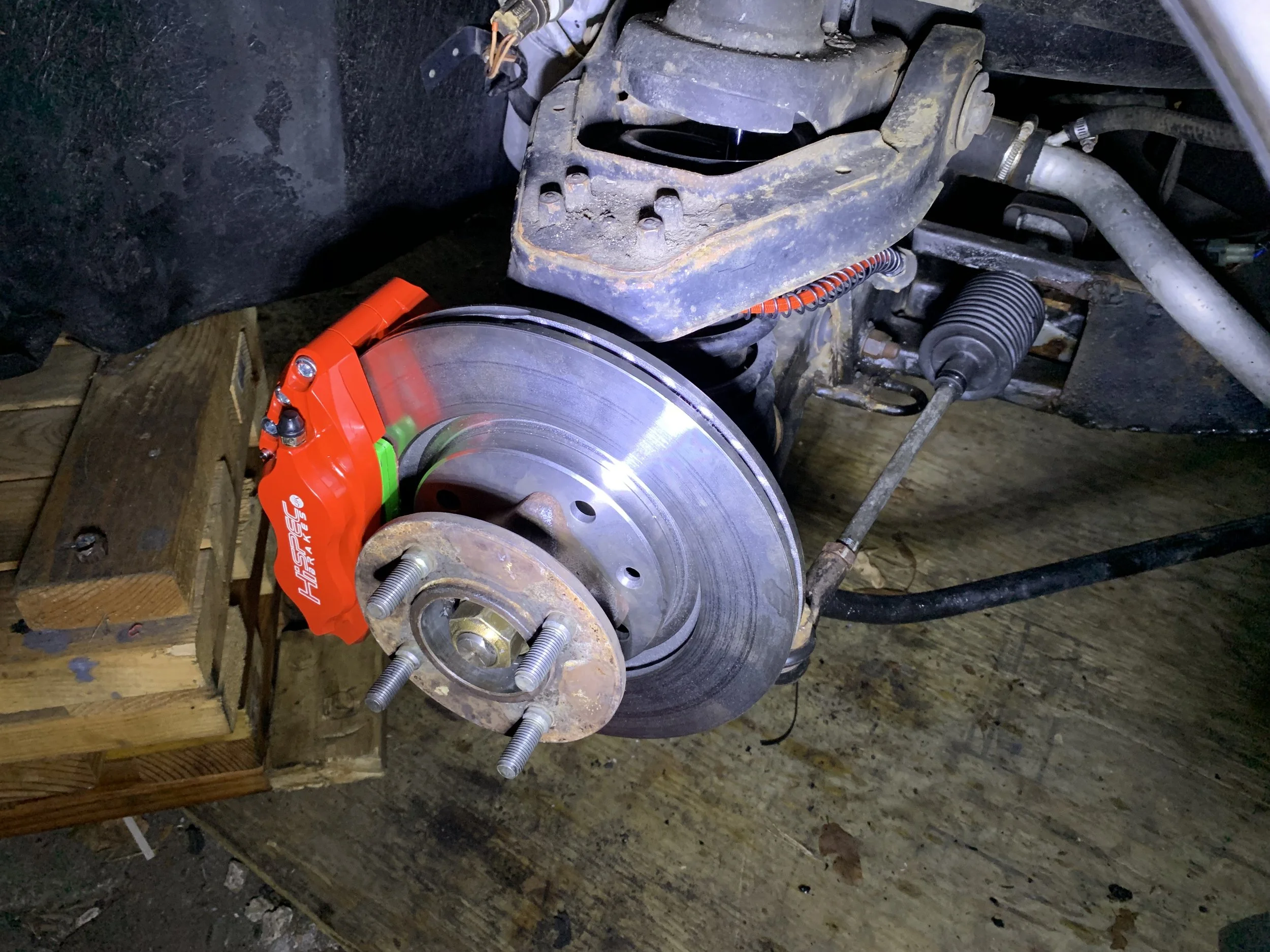 Final installation of the passenger side rotor. The brake line can be seen on the right side of the image.