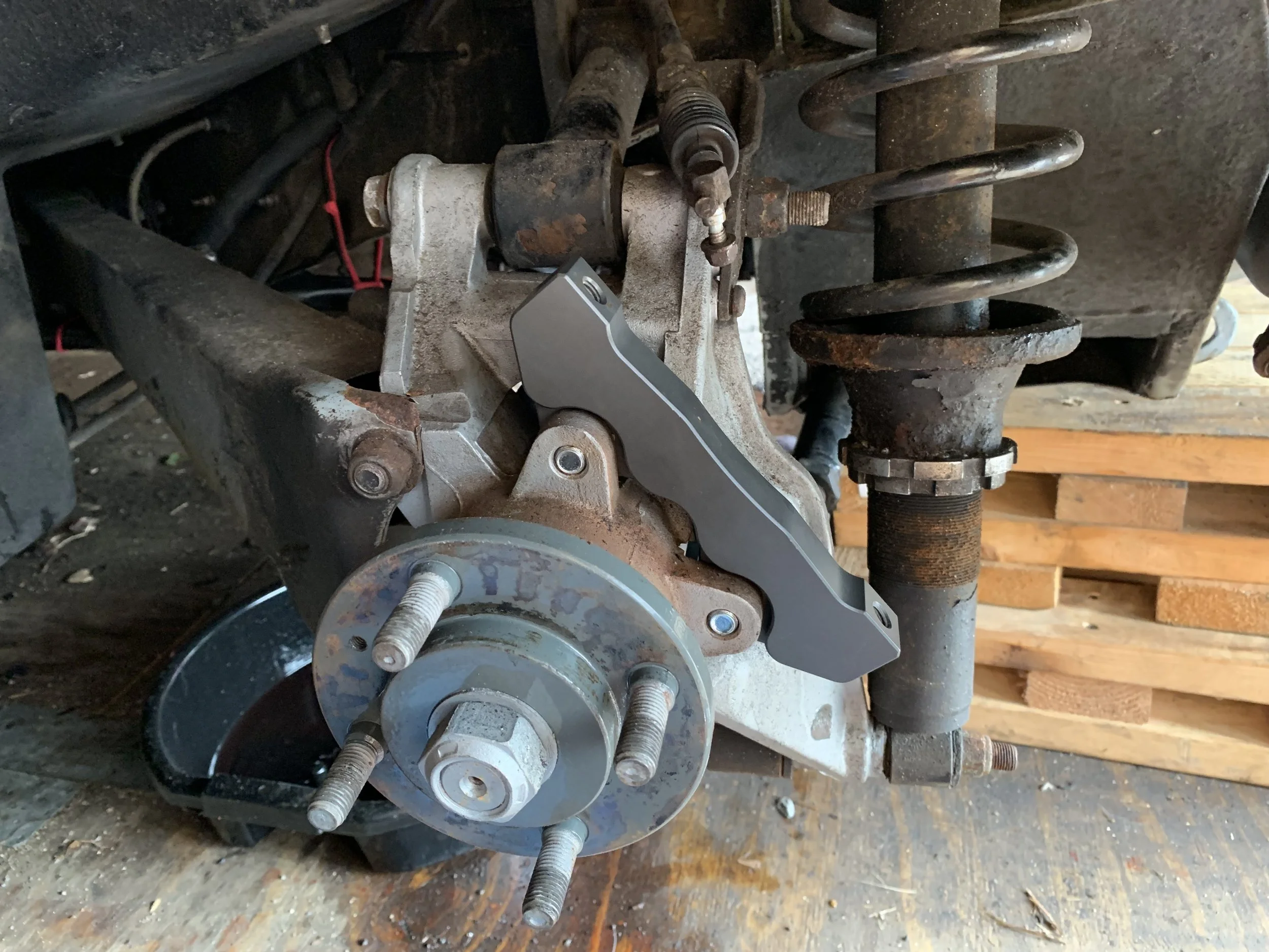 The mount for the caliper installed to the hub carrier.