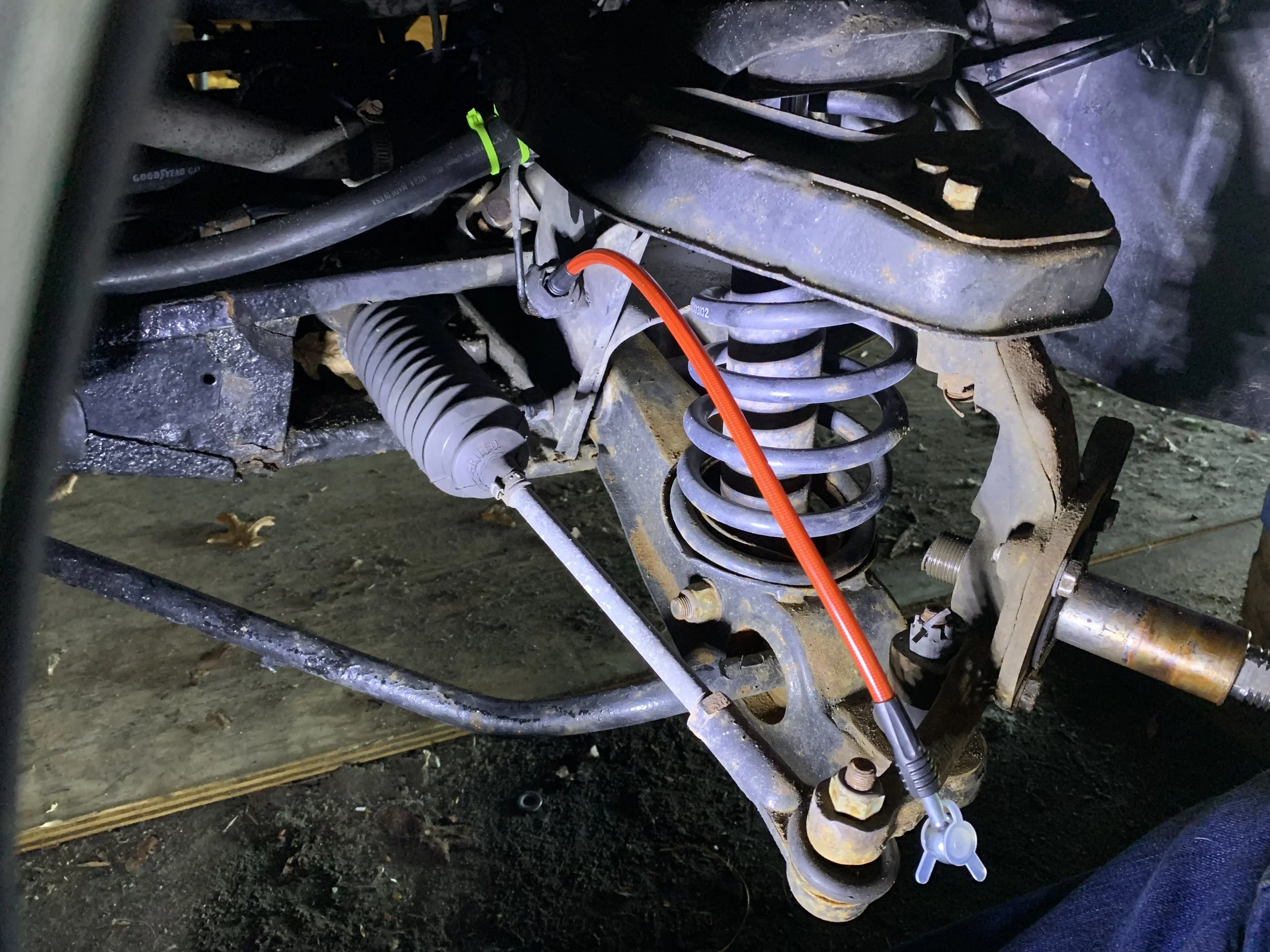The new brake line installed on the hard line. The spring-like protector was installed over the line later.