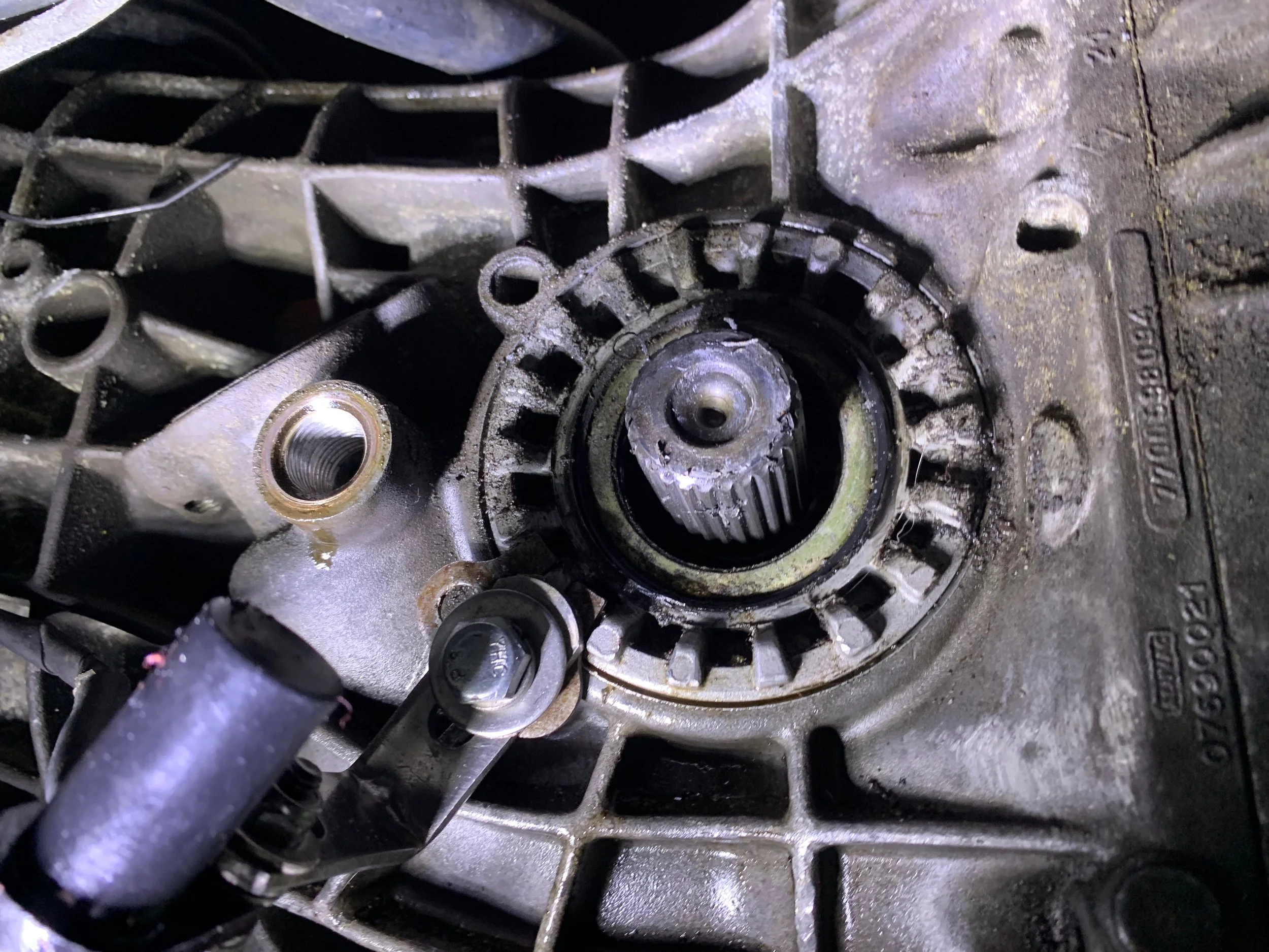 The shaft after removing the flange. The old lip seal can be seen around the shaft, slightly tilted.