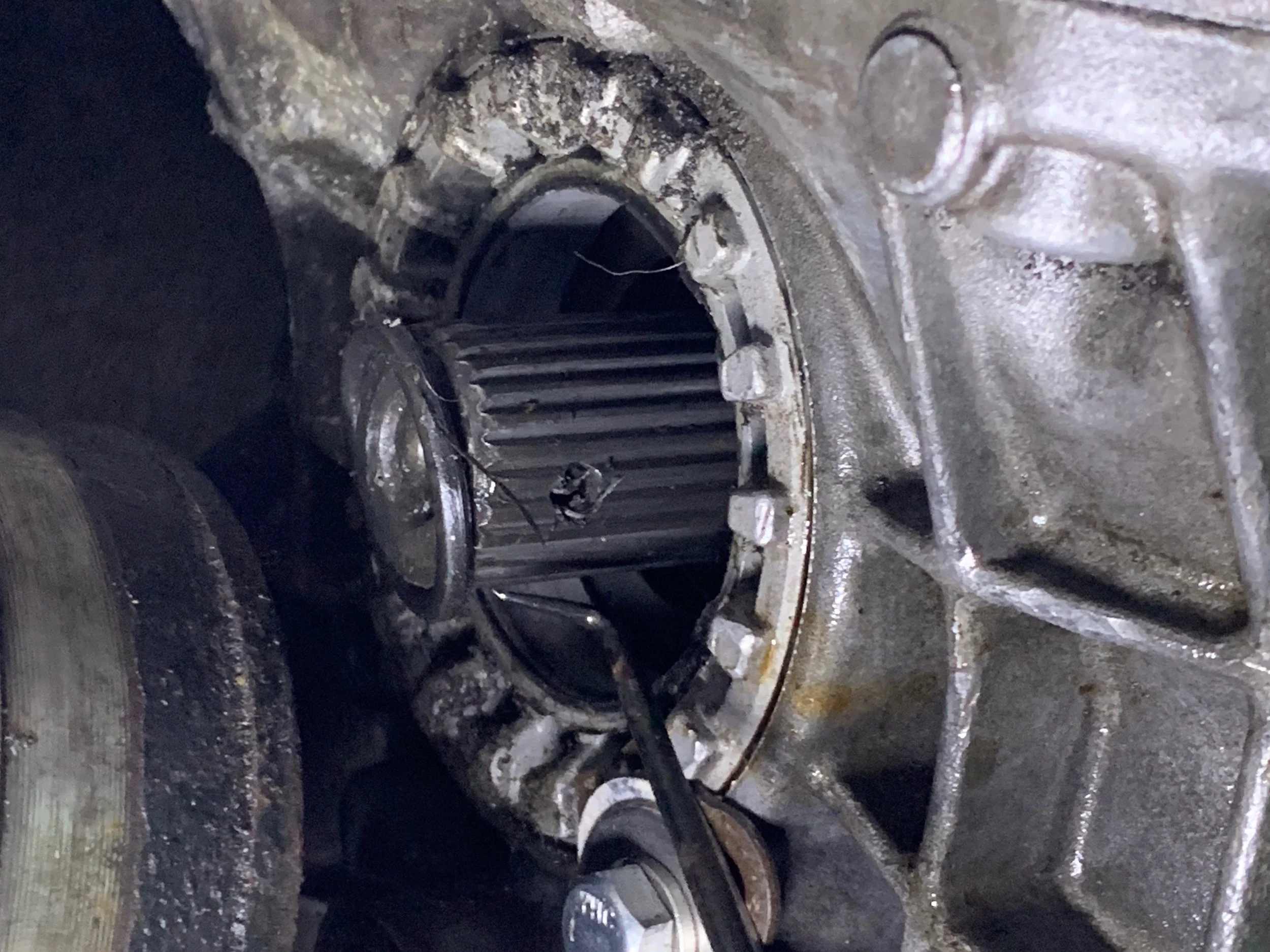 Using a pick to slide the O-ring off of the shaft.