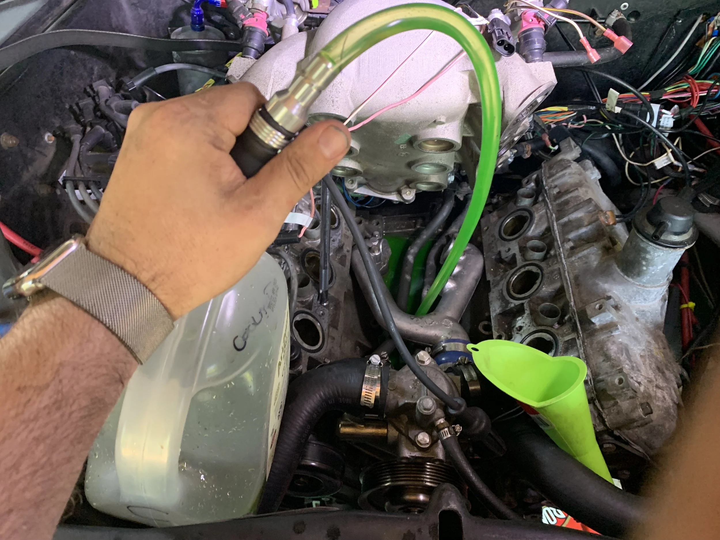Siphoning out all the coolant I spilled into the “V”.