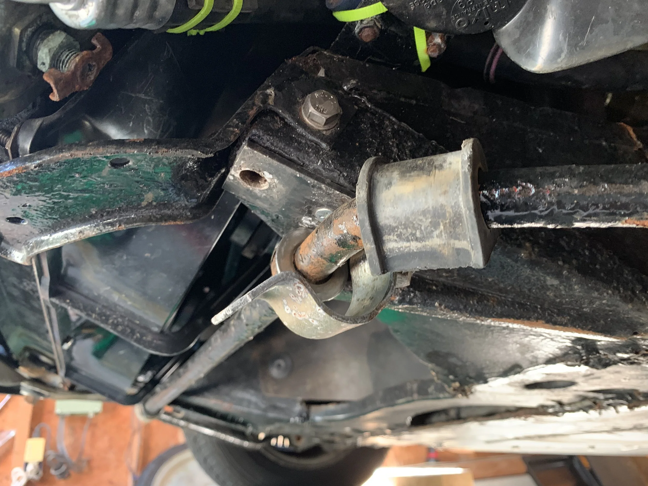 The missing bolt and bent bracket.