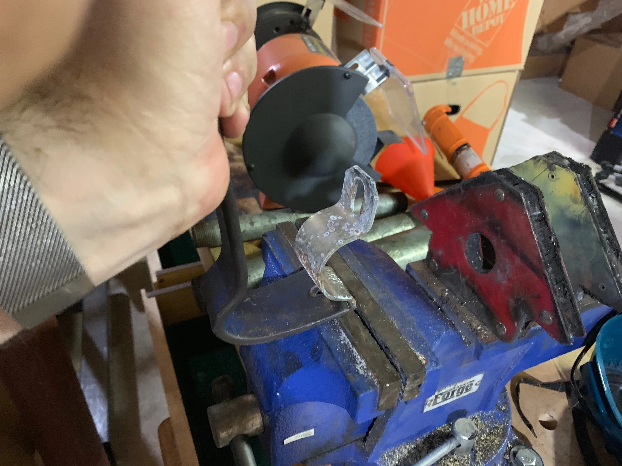 Un-bending the bracket with a vice and a pry bar.