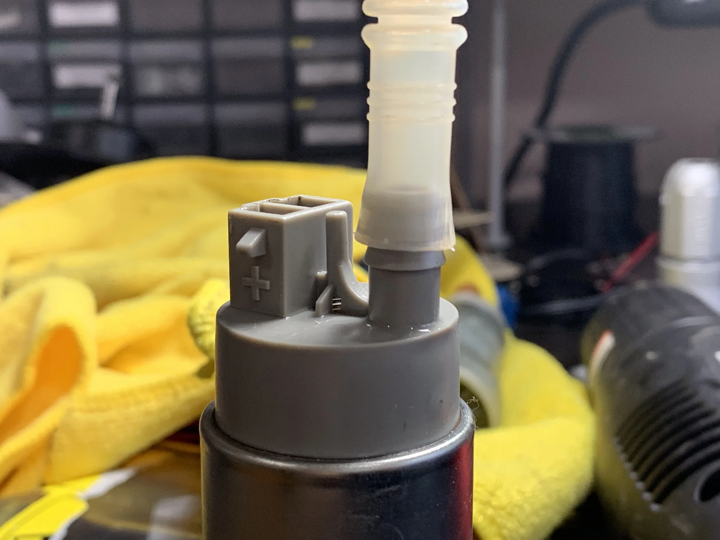 Trying to get the hose on the pump. It needs to go past the bottom barb as well as the top one.
