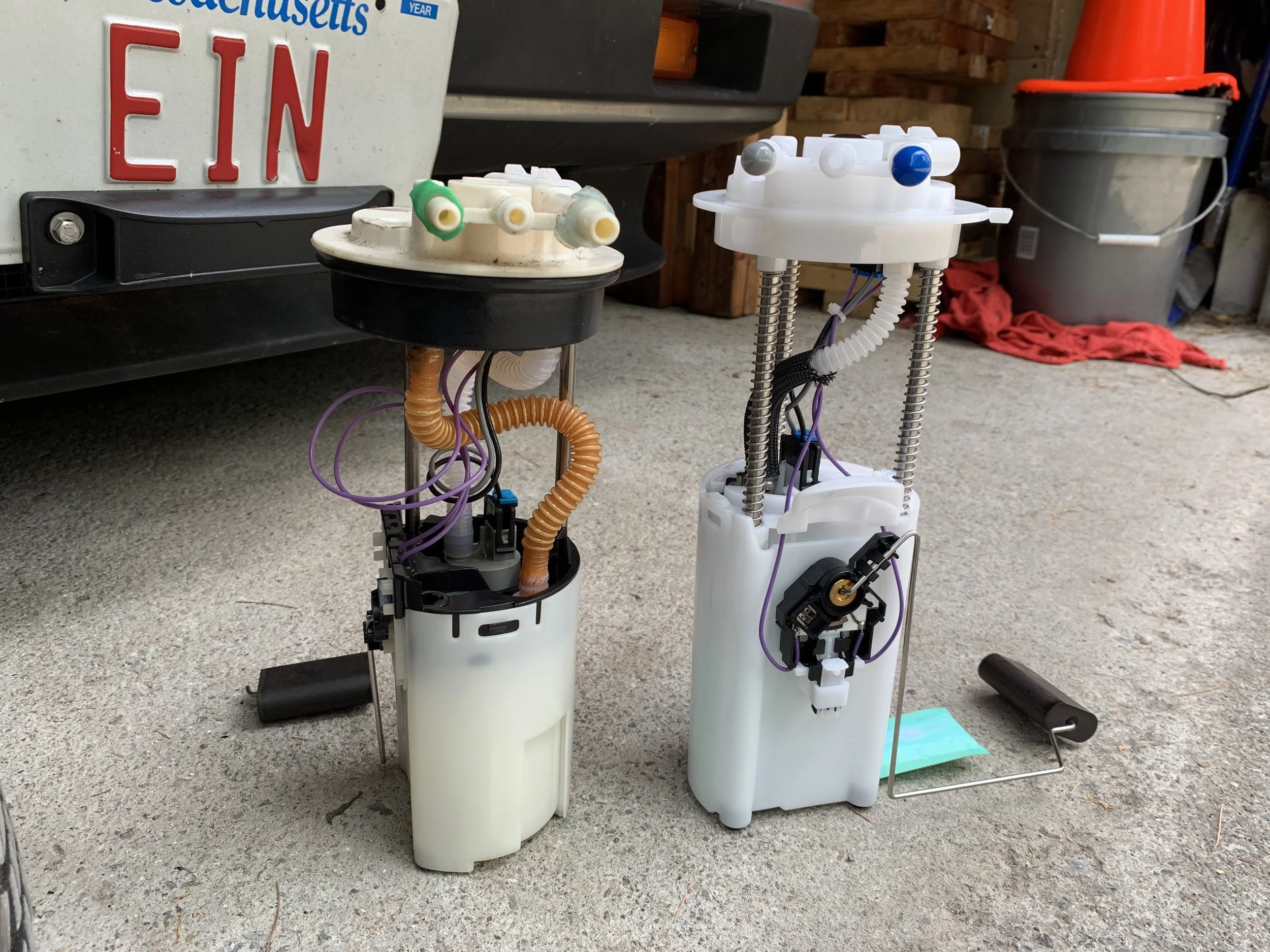 Another view of the two pumps, showing the height difference more clearly. Both pumps fit properly in the tank.