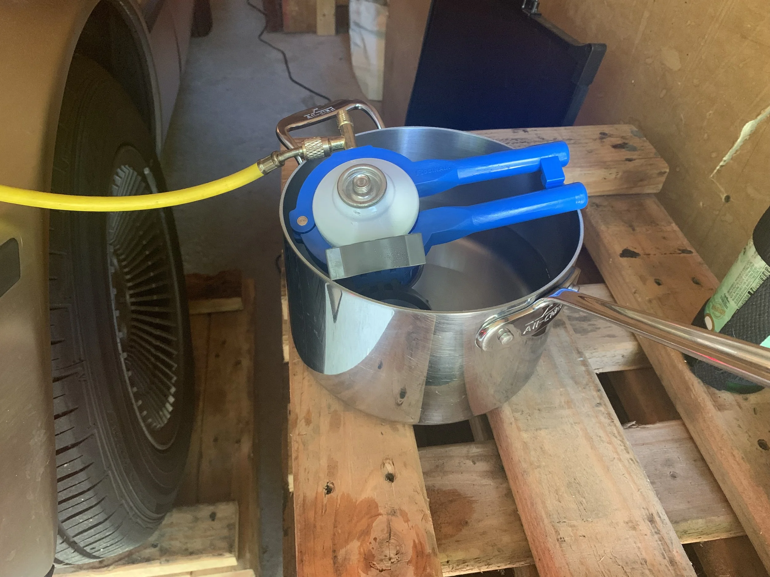Getting more refrigerant out of a can of R134a by placing it in a pot of hot water. The side can tap that I used to pierce the can is also clearly visible here.