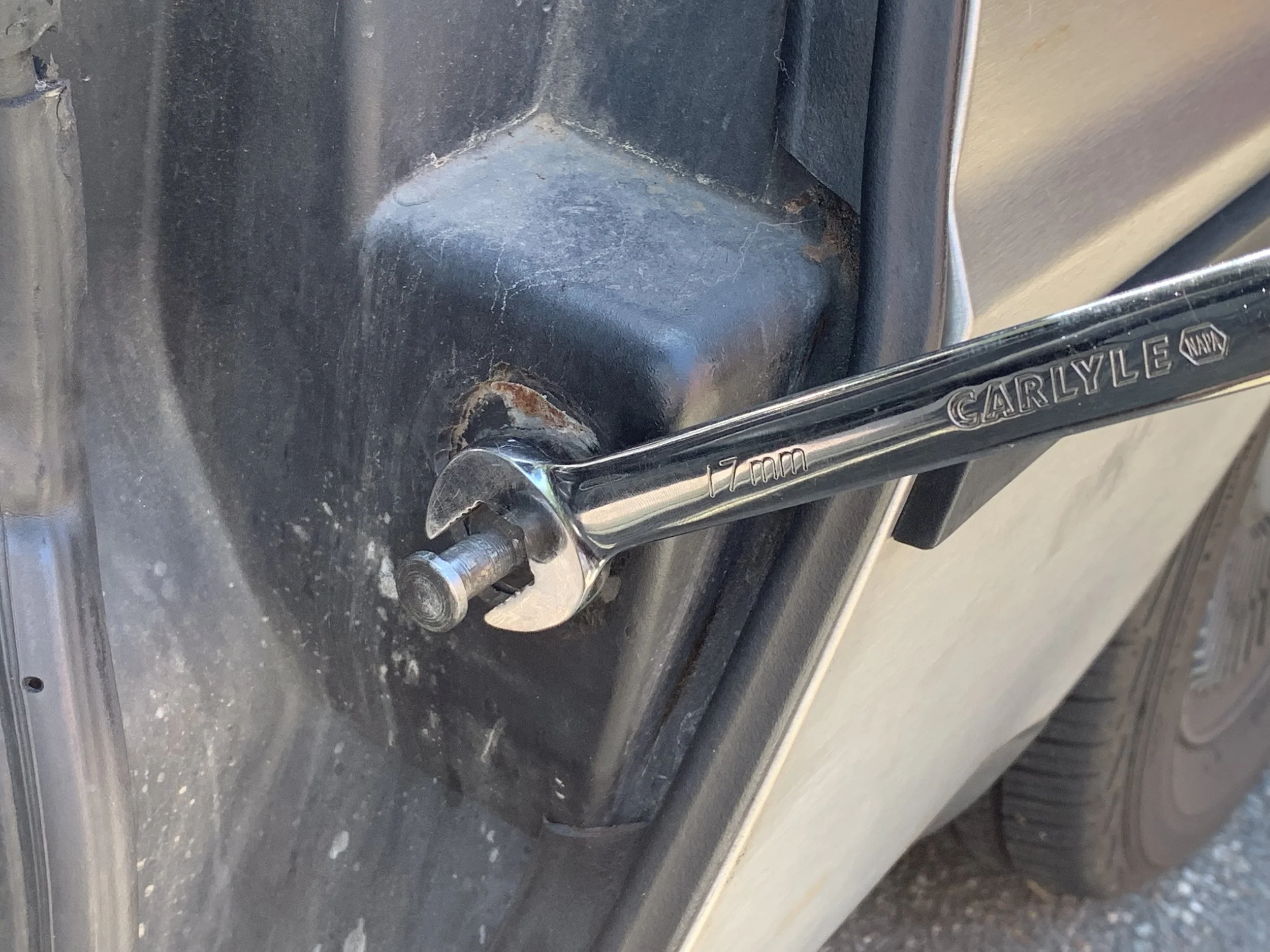 Using a 17mm wrench to loosen the striker.