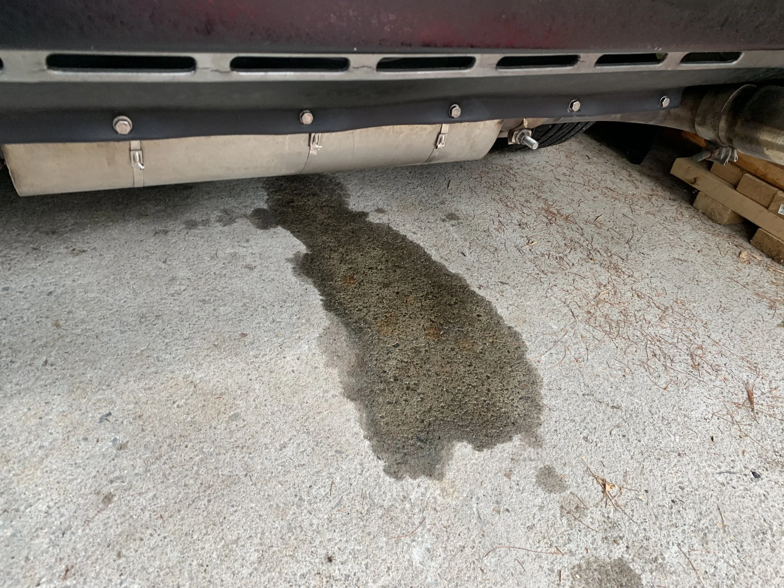 The puddle under the car from the failed filter.