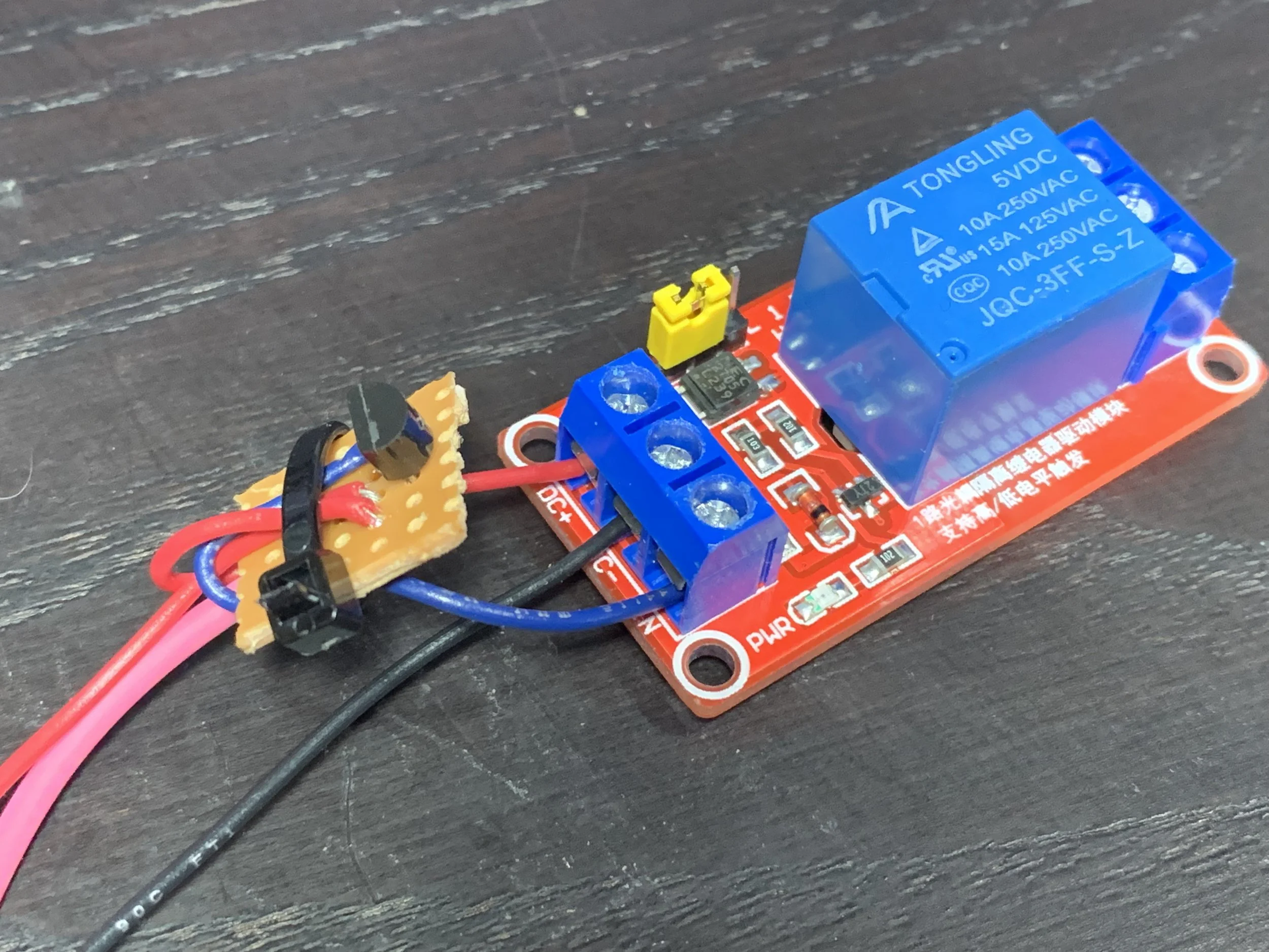 The relay board passing through a transistor. Although the board uses 5v, it may draw too much current for the MegaSquirt pin, so using a transistor or (in this case) MOSFET protects the microcontroller.