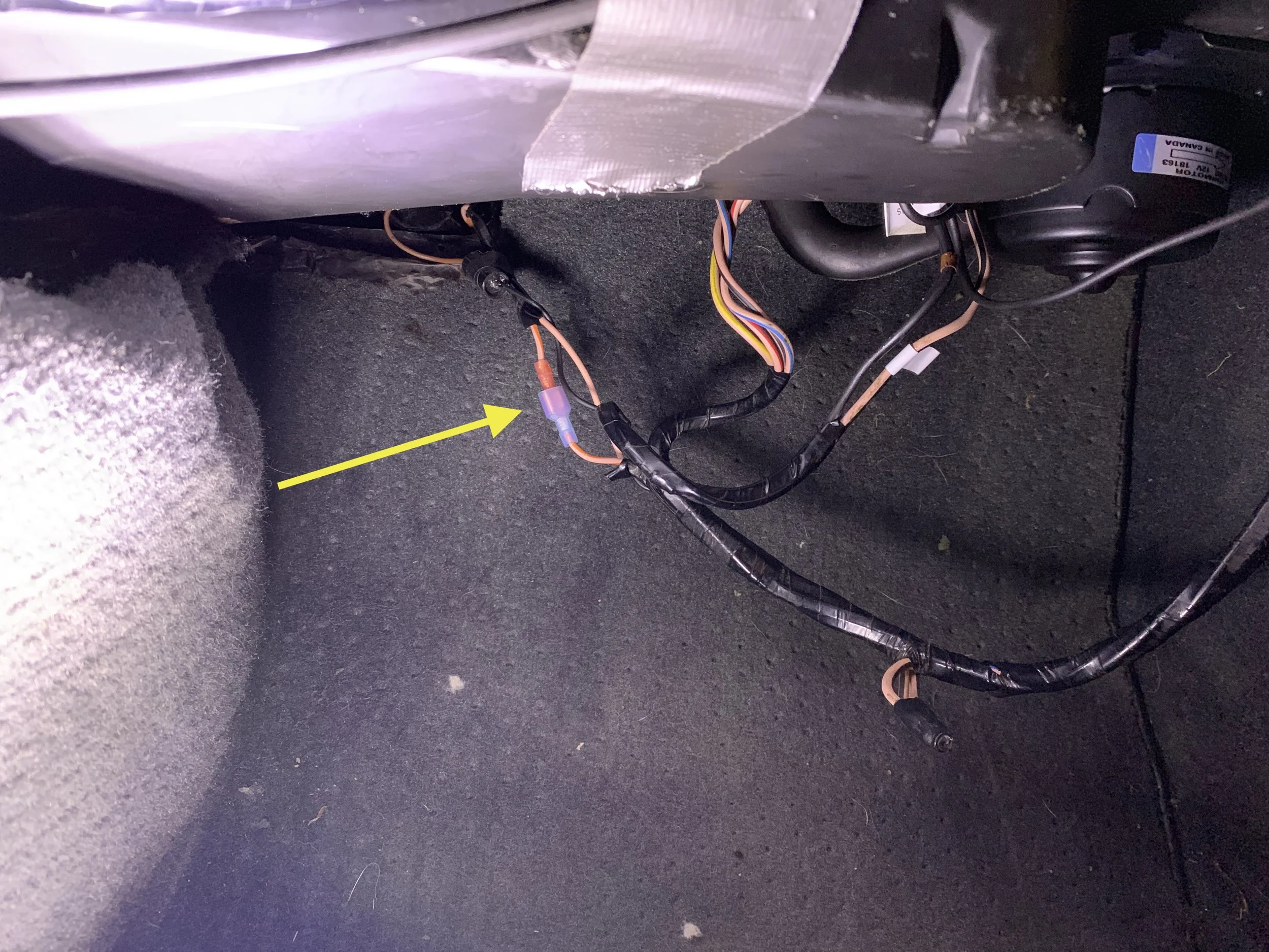 The K/O wire, with blade connectors already added to the cut wire. The pink wire next to it runs from the low pressure switch to the compressor, and should not be modified.