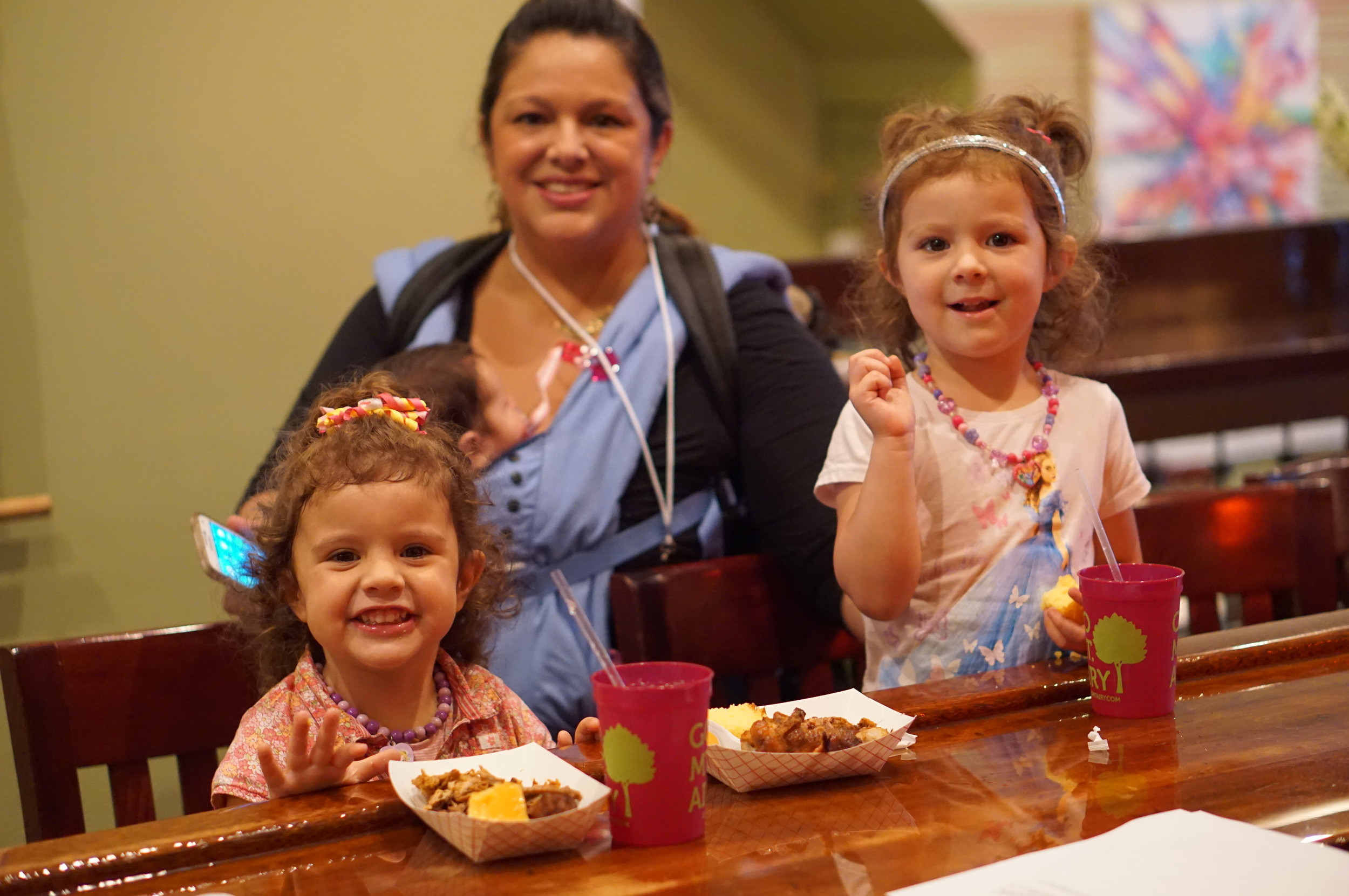 Noelle Kelly and her two little ones enjoy tasty bites on the Street Fare media preview.JPG