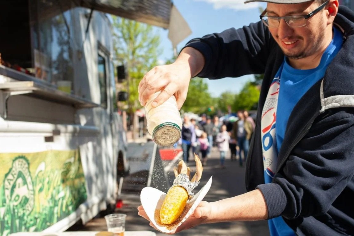 Festivalgoer enjoying food truck snack at the Roxborough Spring Festival and Car Show