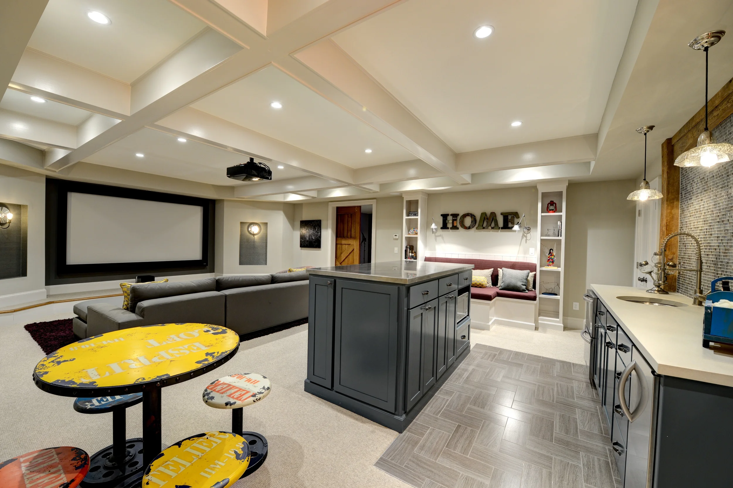 This project included taking an unfinished basement and transforming it into a living space that included a multi-purpose home theatre room, a playroom, and a bathroom. The Consulting House created the layout & CAD drawings, designed and selected all elements, and decorated the spaces.