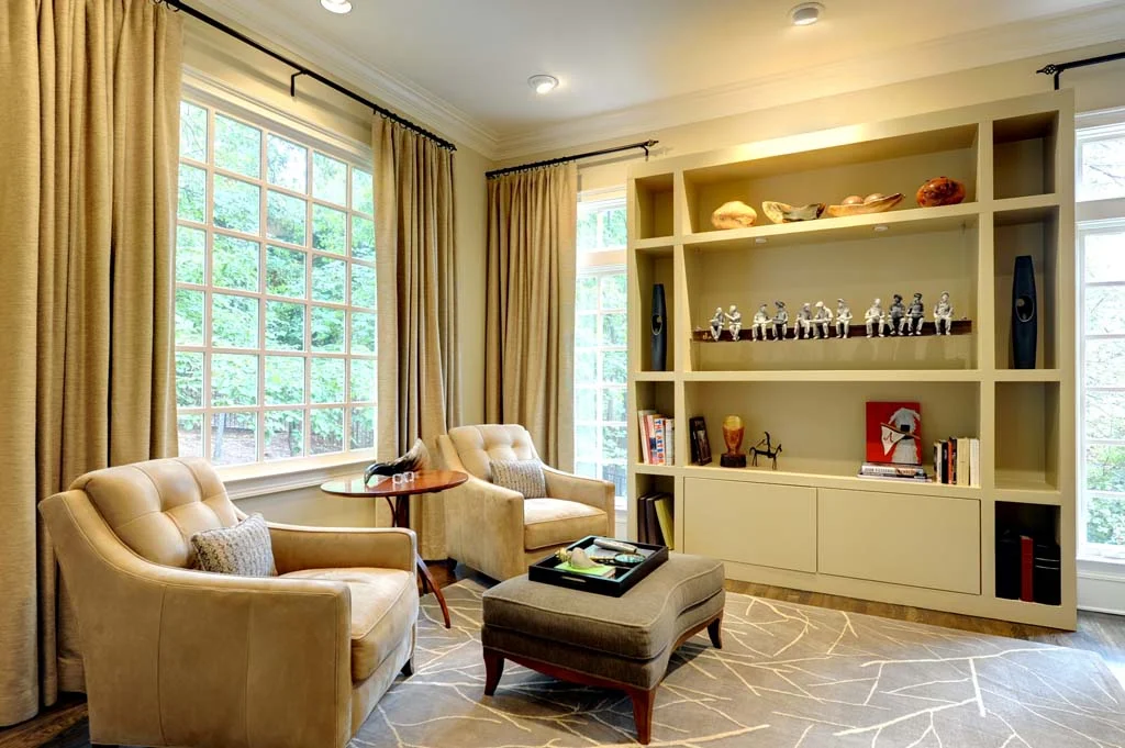 The hardwood floors were darkened and the den was finished out with all new purchases. The cabinetry was custom designed by The Consulting House to display a sculptural art work and provide closed storage for photo albums and books. 
