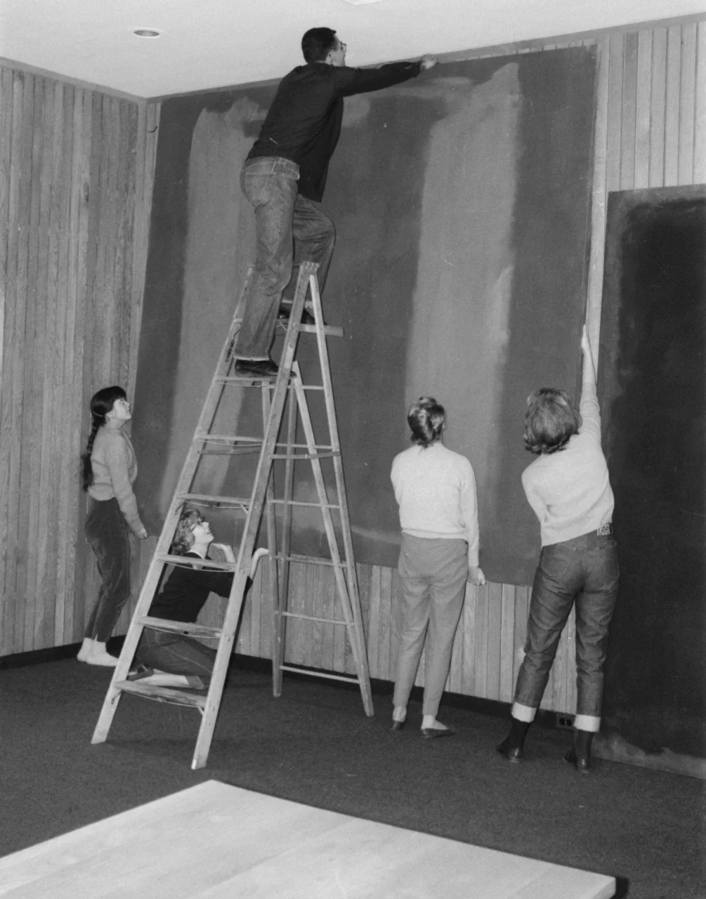 Students assisting with the hanging of Panel 1
