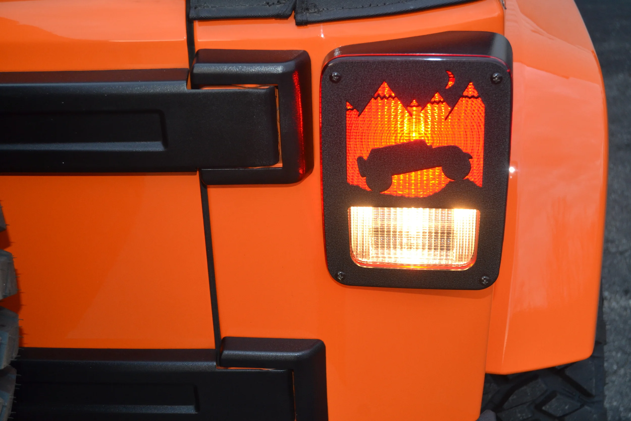 BLACK JK (2007-PRESENT) JEEP TERRAIN DESIGN SHOWN ABOVE. NEW DESIGN. ALL OUR TAILLIGHT GUARDS ARE REVERSABLE. JEEP IMAGE CAN FACE OUTWARDS OR TOWARDS EACH OTHER.