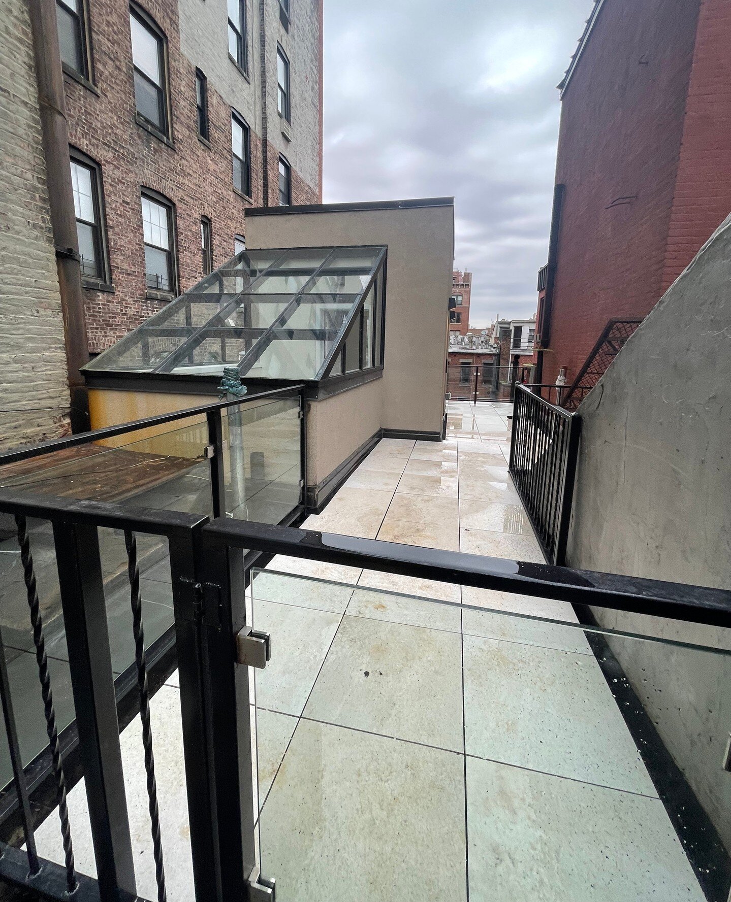 An unused rooftop becomes the Penthouse level! A new glass enclosed staircase winds up to the new top floor, with new energy efficient HVAC systems, exterior lighting and a massive roofdeck finished with natural stone pavers and a custom glass railin