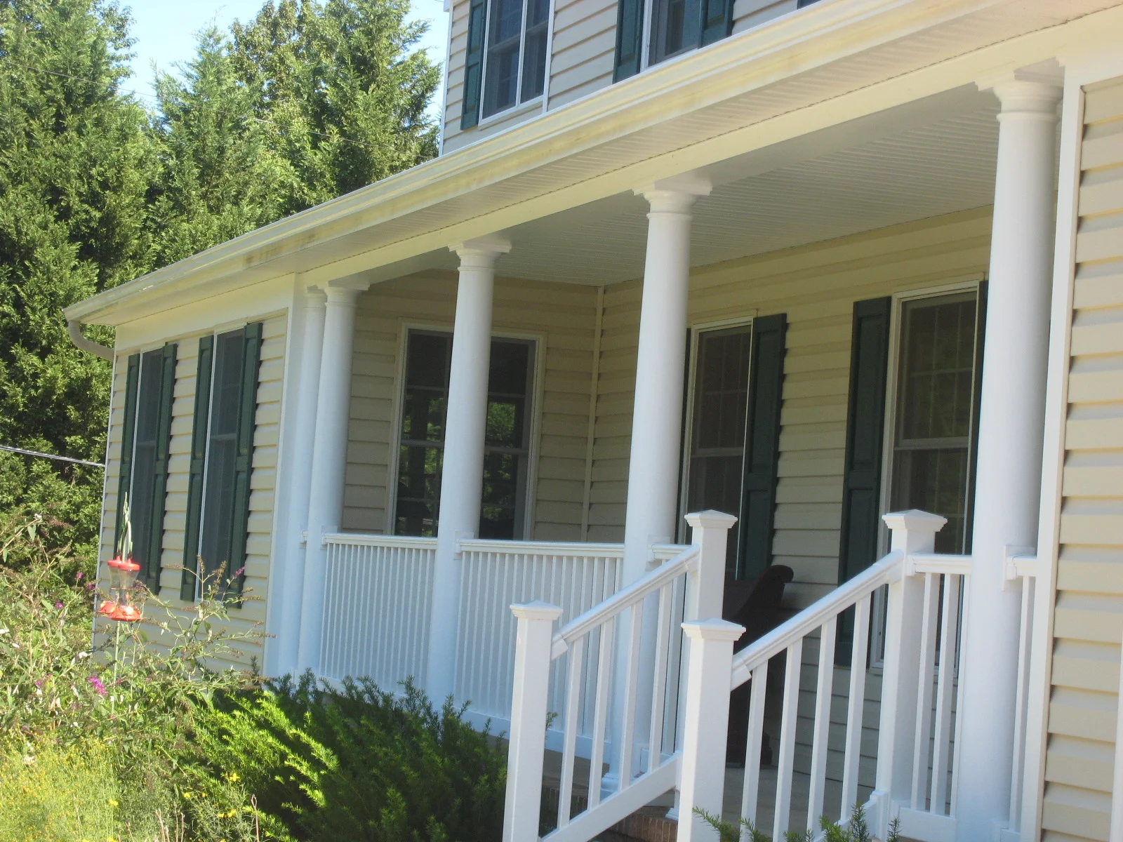 After: the existing porch roof plane extends over the front of the new addition. The porch columns and rails were also redesigned to avoid the "toothpick" effect of too-small posts.